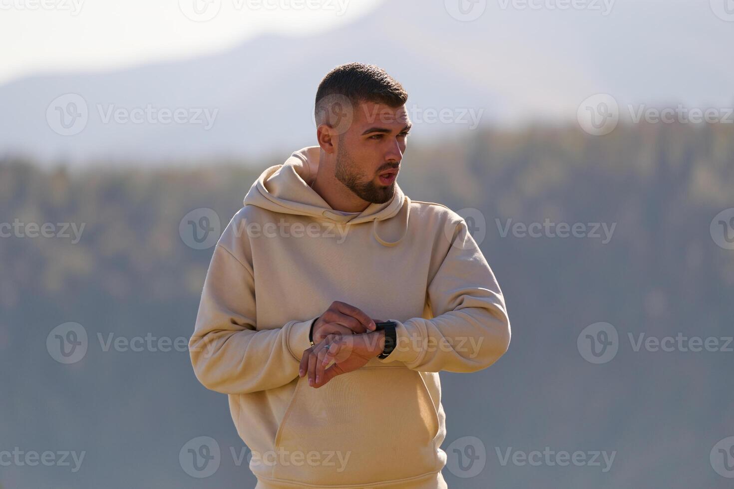 Athletic man maintains his healthy lifestyle by running through the scenic mountain and lakeside environment, showcasing a commitment to fitness and well-being photo