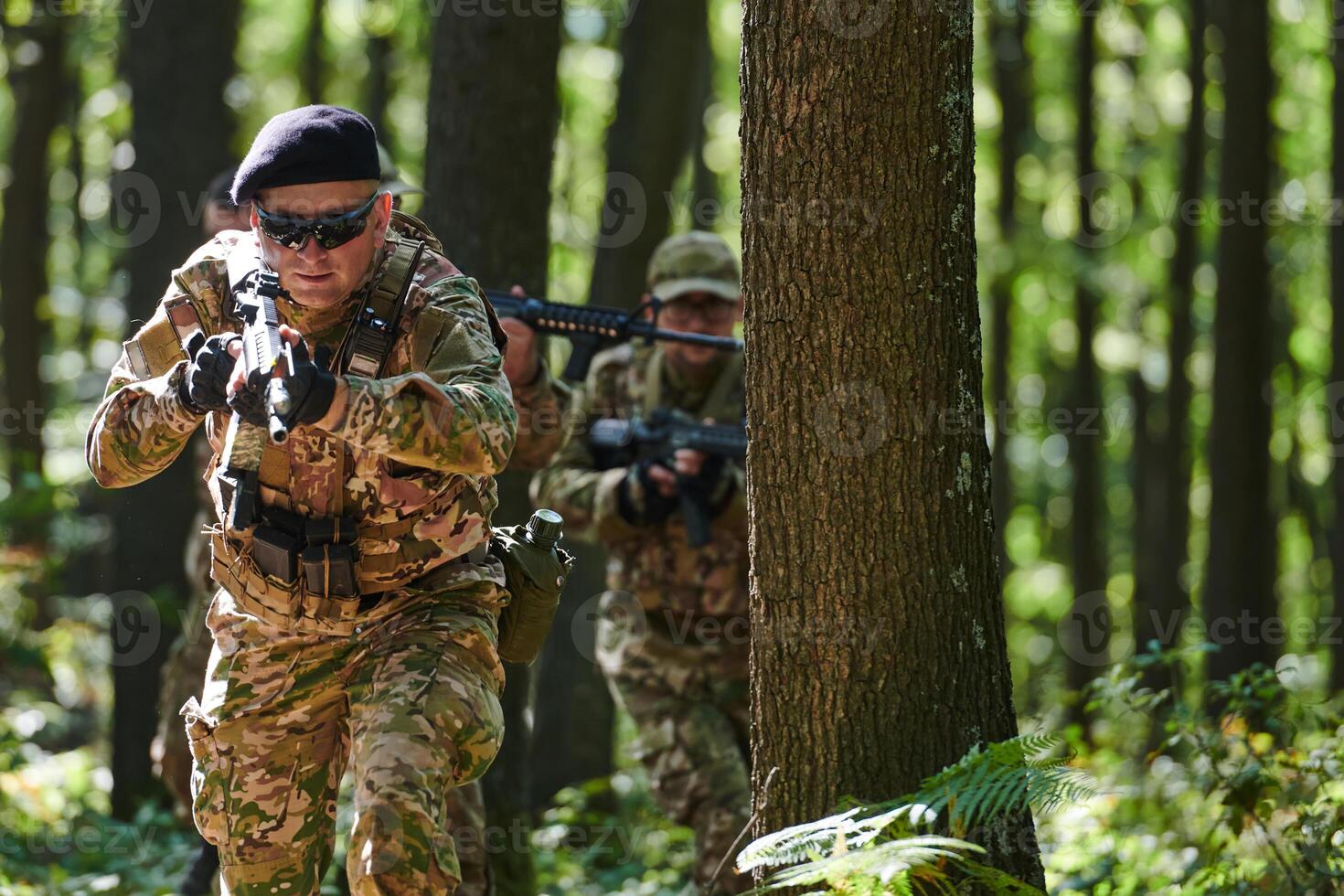 A specialized military antiterrorist unit conducts a covert operation in dense, hazardous woodland, demonstrating precision, discipline, and strategic readiness photo