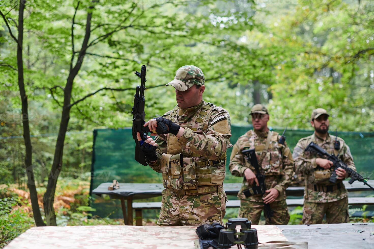 An elite military unit prepares for a hazardous forest operation, showcasing tactical prowess, camouflage skills, and strategic readiness photo