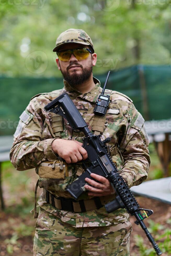 Elite soldier exudes focused determination and readiness, geared up for a perilous military operation, capturing the essence of courage and professionalism in the face of imminent danger photo