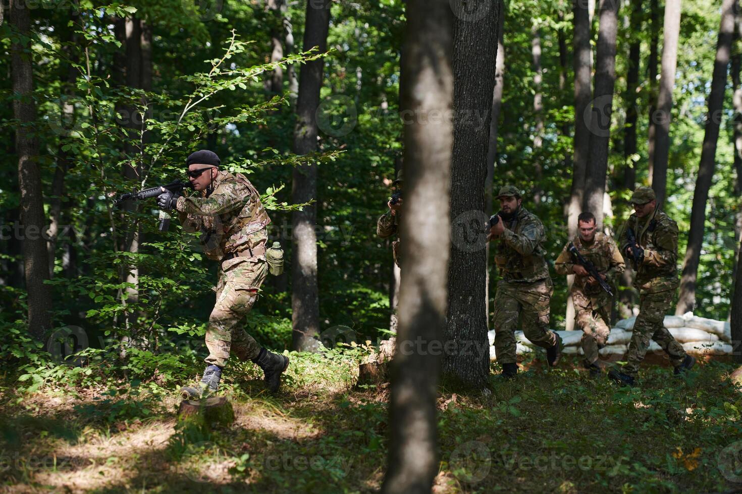 A specialized military antiterrorist unit conducts a covert operation in dense, hazardous woodland, demonstrating precision, discipline, and strategic readiness photo