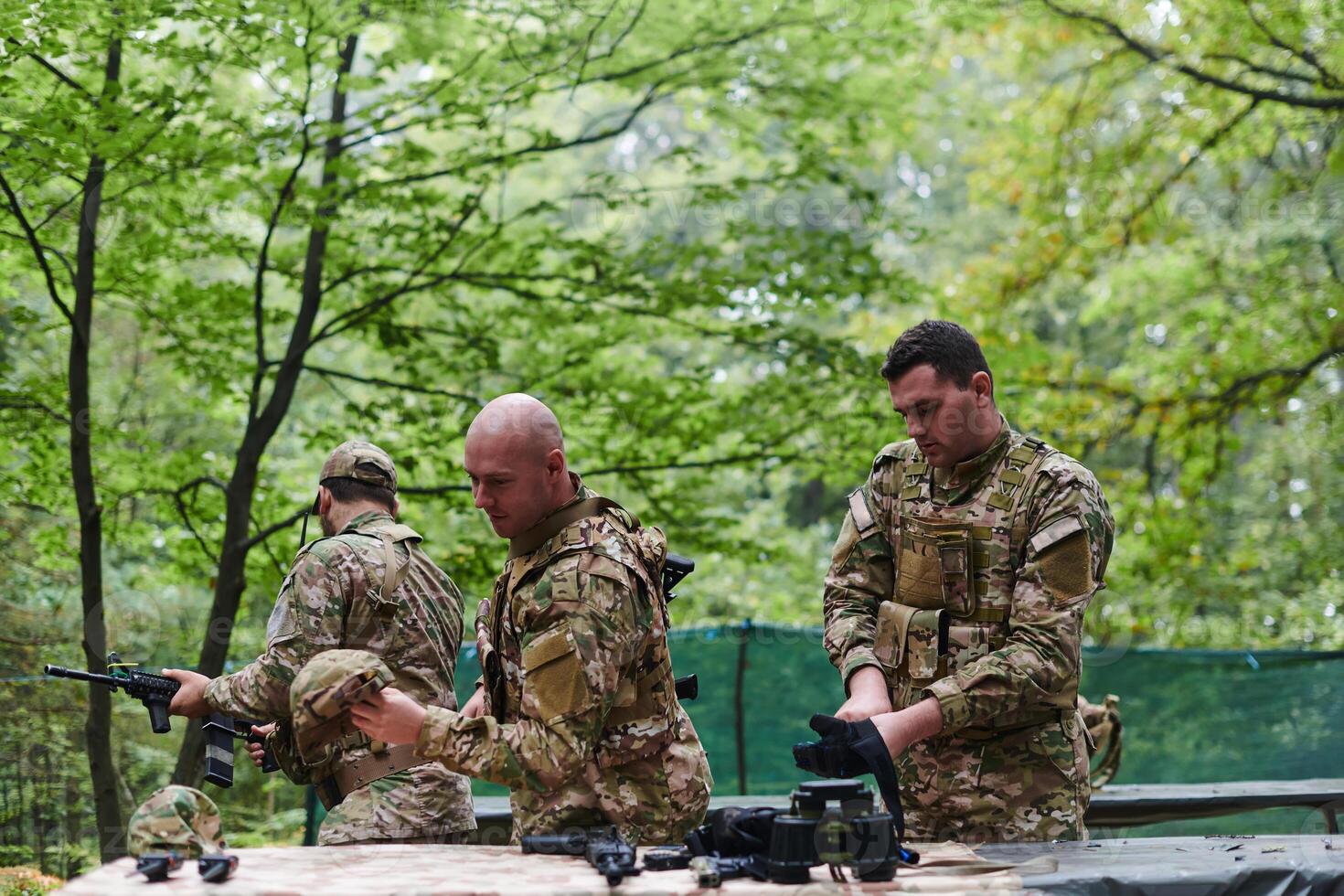 An elite military unit prepares for a hazardous forest operation, showcasing tactical prowess, camouflage skills, and strategic readiness photo