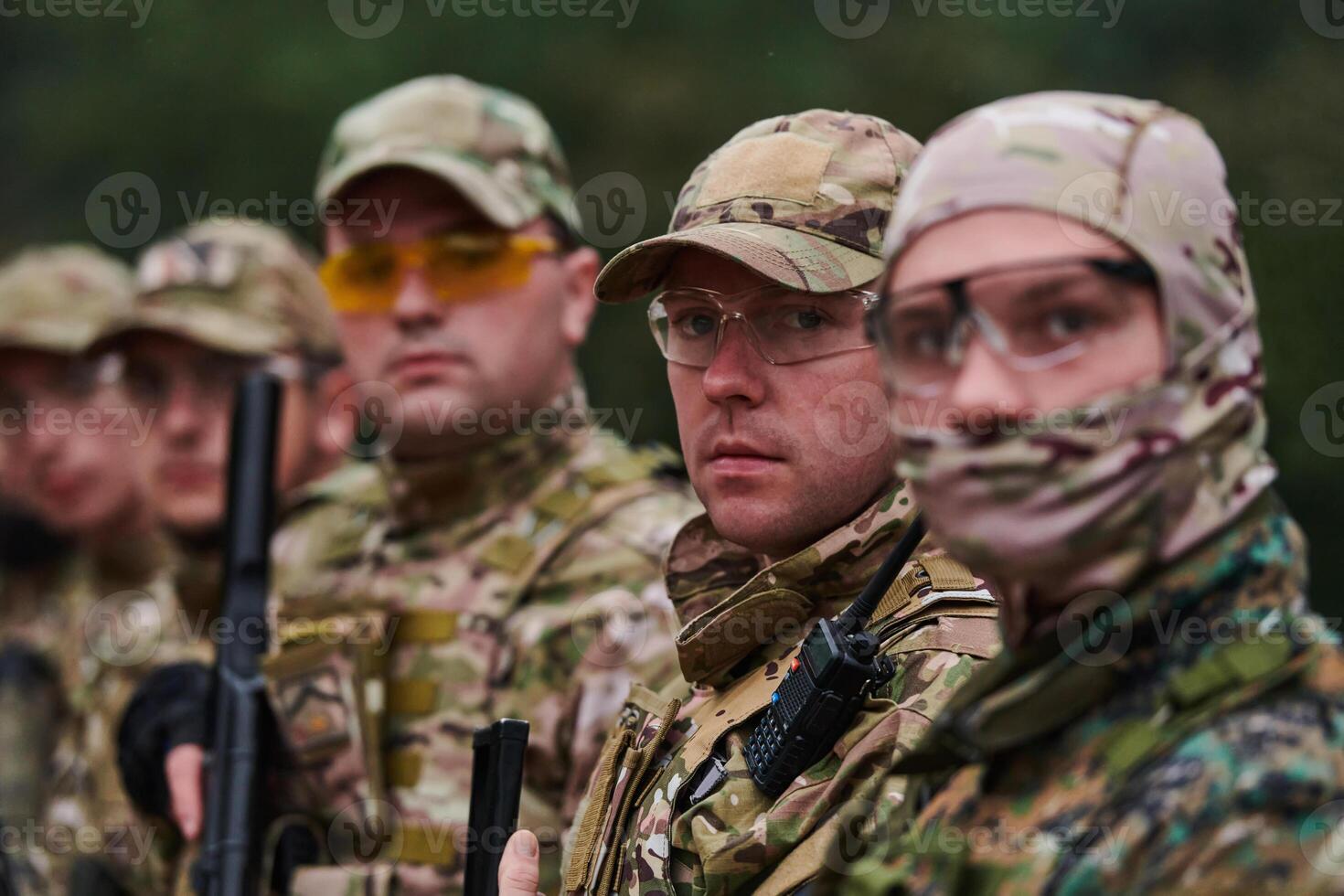 Soldier fighters standing together with guns. Group portrait of US army elite members, private military company servicemen, anti terrorist squad photo