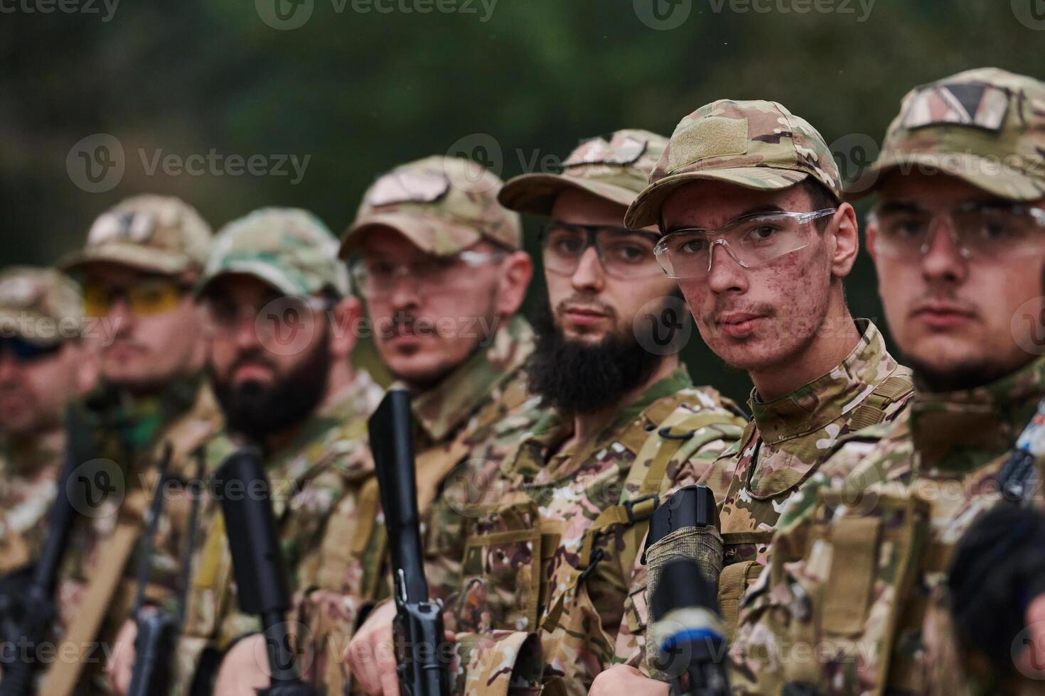 Soldier fighters standing together with guns. Group portrait of US army elite members, private military company servicemen, anti terrorist squad photo