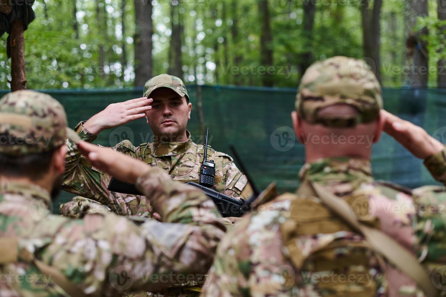 A dedicated soldier salutes his elite unit, showcasing camaraderie and readiness for the most perilous military operations photo