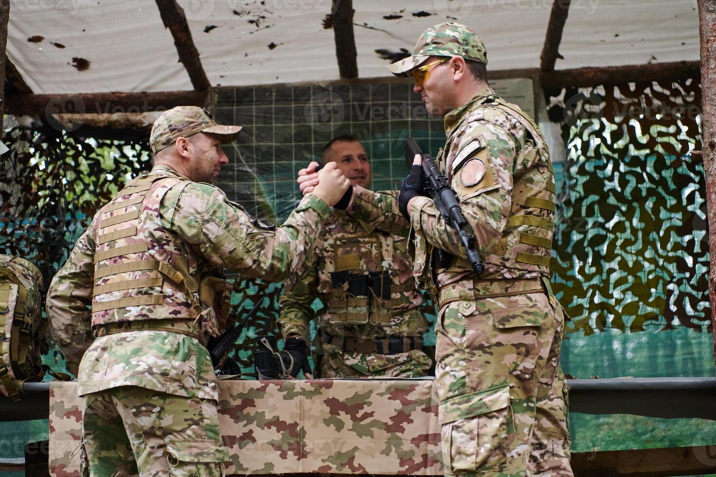 A highly trained military unit strategizes and organizes a tactical mission while studying a military map during a briefing session photo