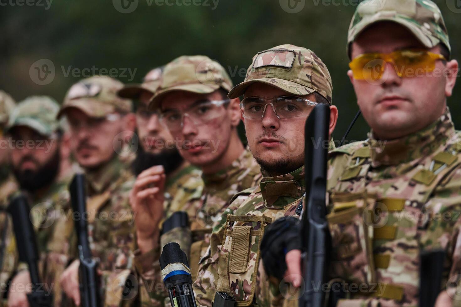 Soldier fighters standing together with guns. Group portrait of US army elite members, private military company servicemen, anti terrorist squad photo