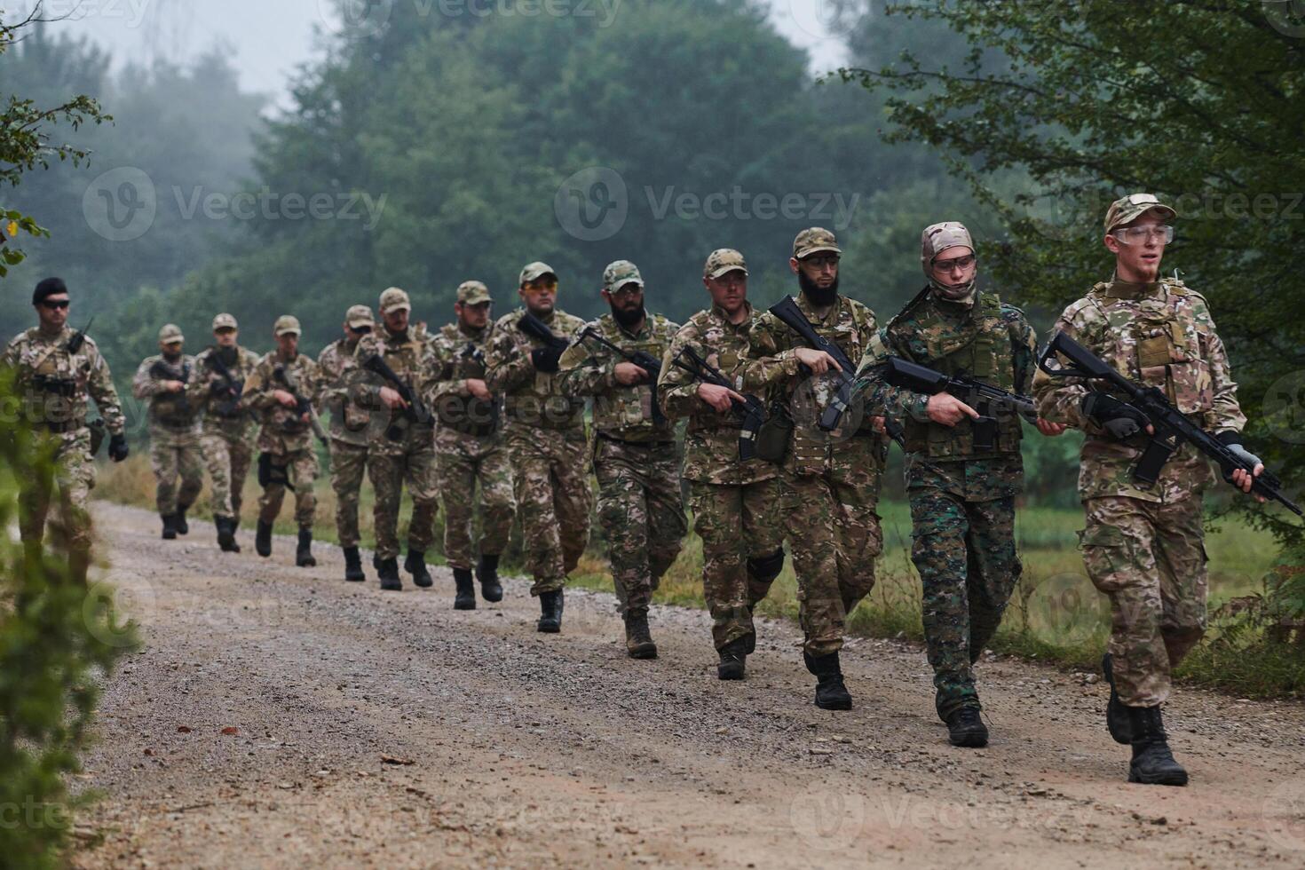 An elite military unit, led by a major, confidently parades through dense forest, showcasing precision, discipline, and readiness for high-risk operations photo