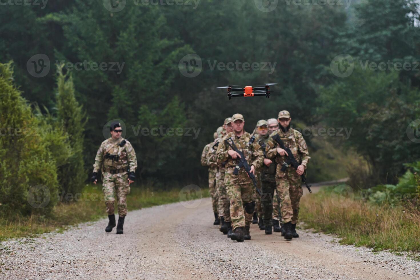 An elite military unit, led by a major, confidently parades through dense forest, showcasing precision, discipline, and readiness for high-risk operations photo