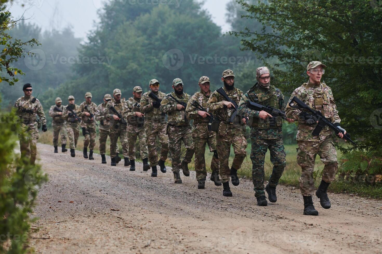 An elite military unit, led by a major, confidently parades through dense forest, showcasing precision, discipline, and readiness for high-risk operations photo