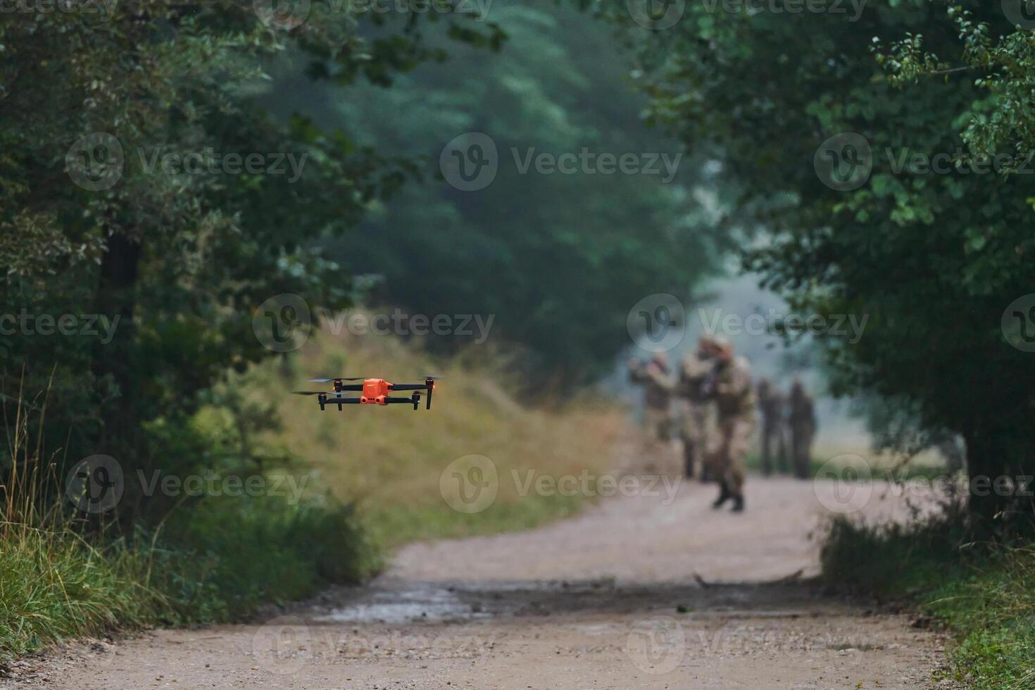 Elite military unit parading and securing the forest, utilizing drones for terrain scanning and reconnaissance, showcasing their advanced skills and specialized training in high risk operations photo