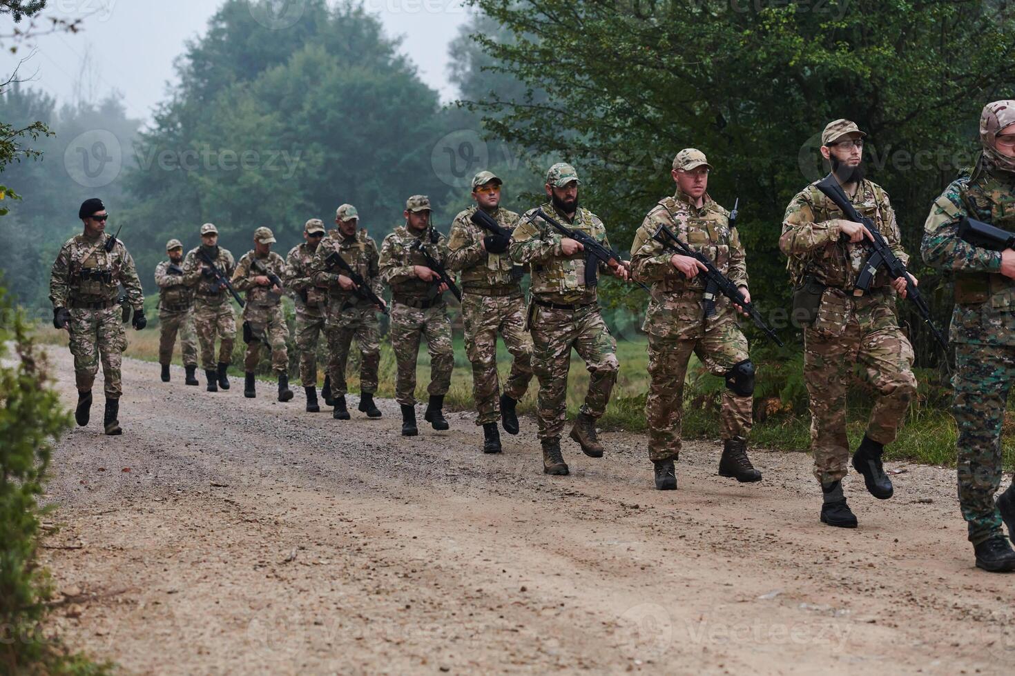 An elite military unit, led by a major, confidently parades through dense forest, showcasing precision, discipline, and readiness for high-risk operations photo