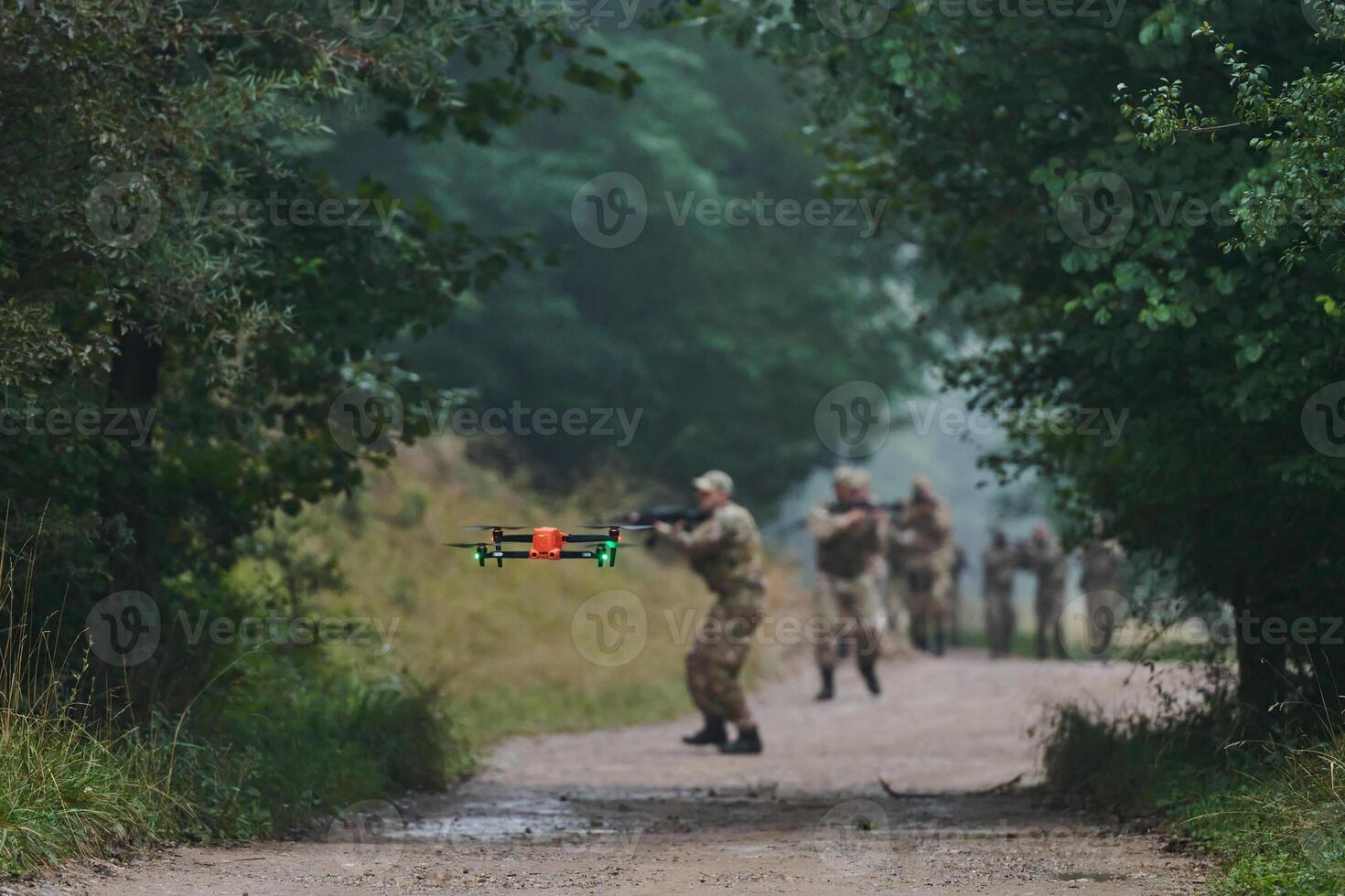 Elite military unit parading and securing the forest, utilizing drones for terrain scanning and reconnaissance, showcasing their advanced skills and specialized training in high risk operations photo