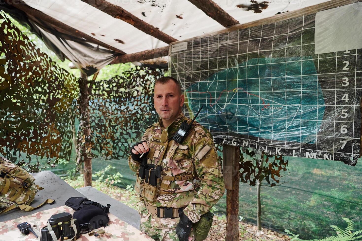 The esteemed leader of an elite military unit, strategic brilliance unfolds as he meticulously devises tactical plans for the upcoming military operation, surrounded by cutting-edge technology and a photo