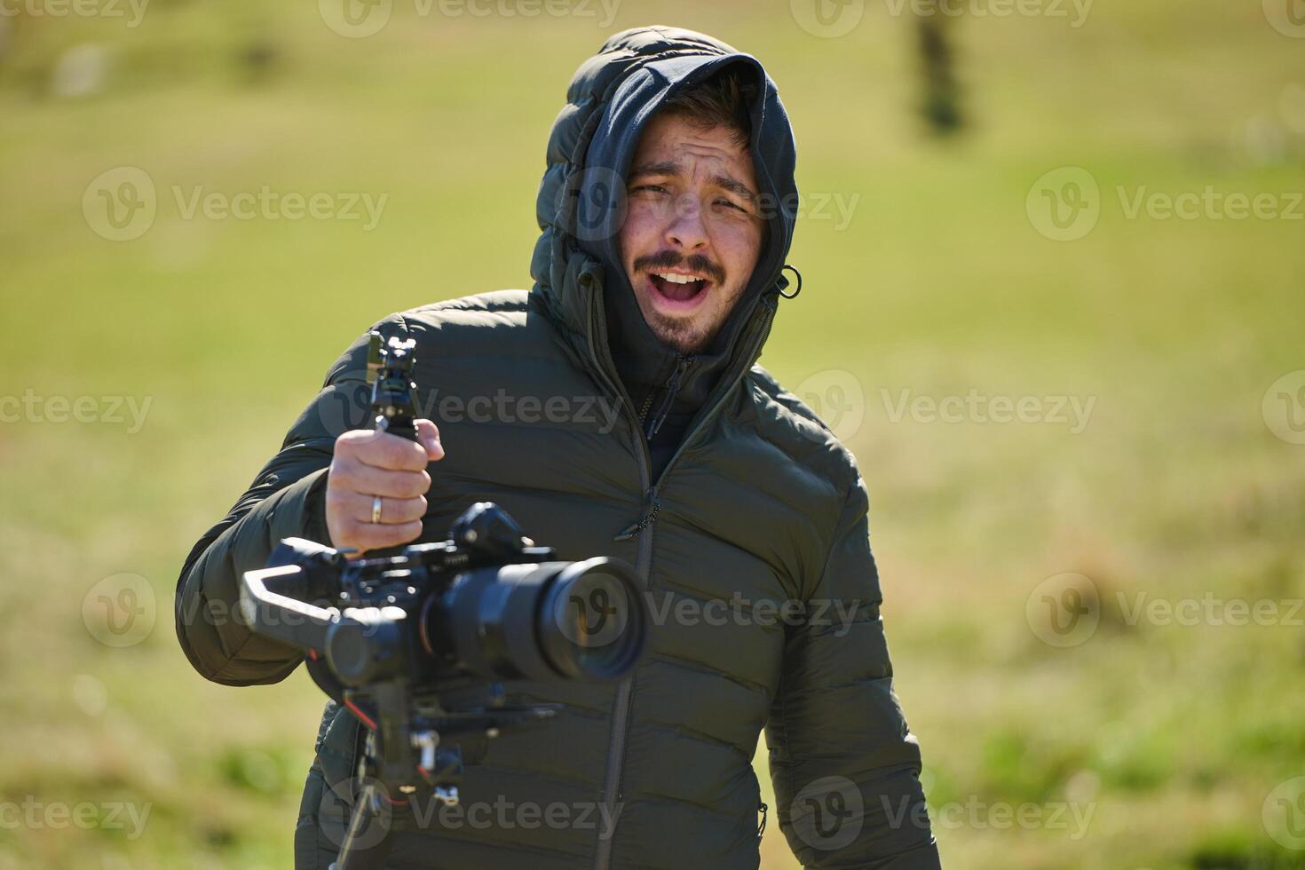 A skilled videographer, equipped with professional gear, captures the essence of nature's beauty, expertly documenting the scenic landscape in a cinematic masterpiece that reflects the seamless blend photo