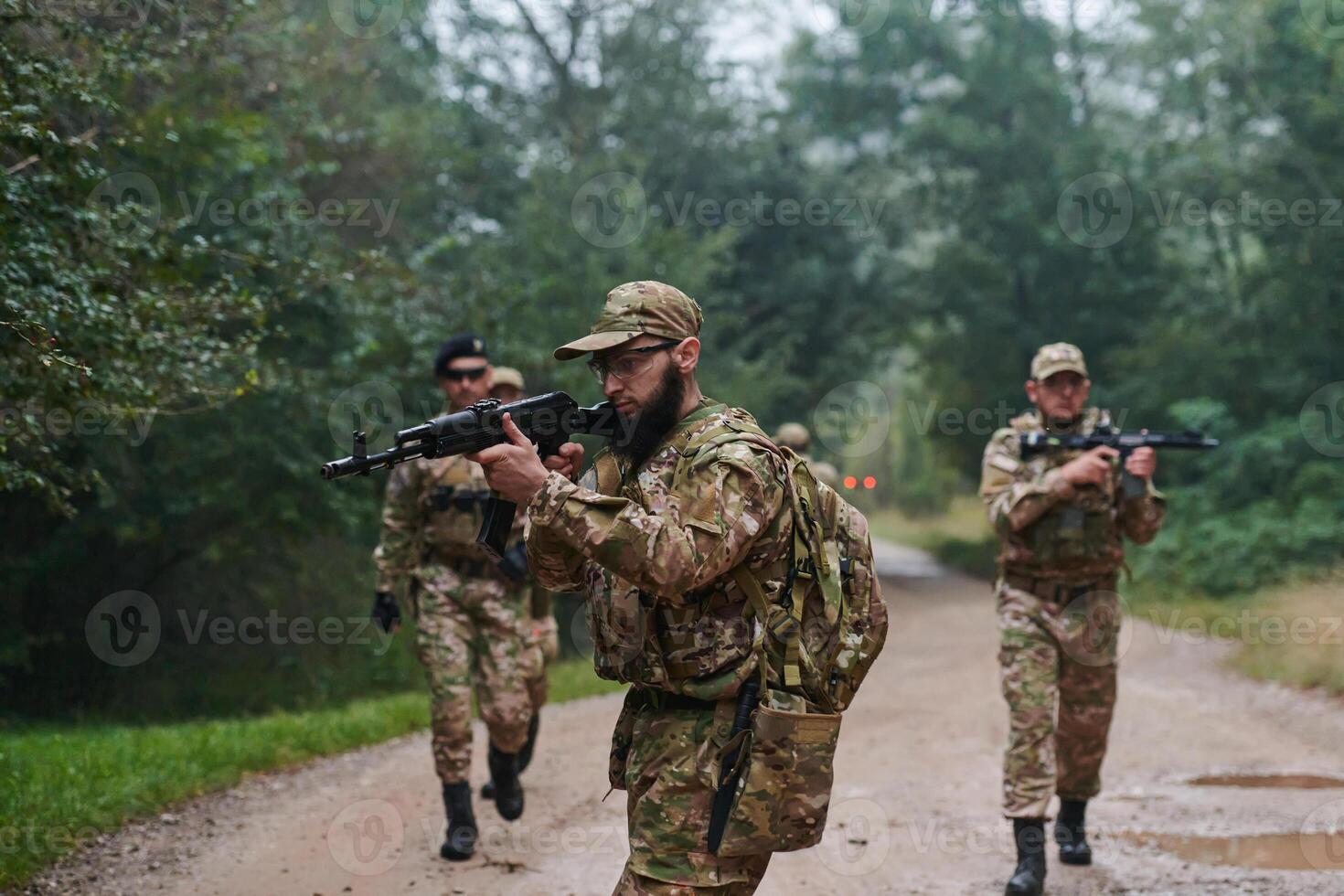 A disciplined and specialized military unit, donned in camouflage, strategically patrolling and maintaining control in a high-stakes environment, showcasing their precision, unity, and readiness for photo