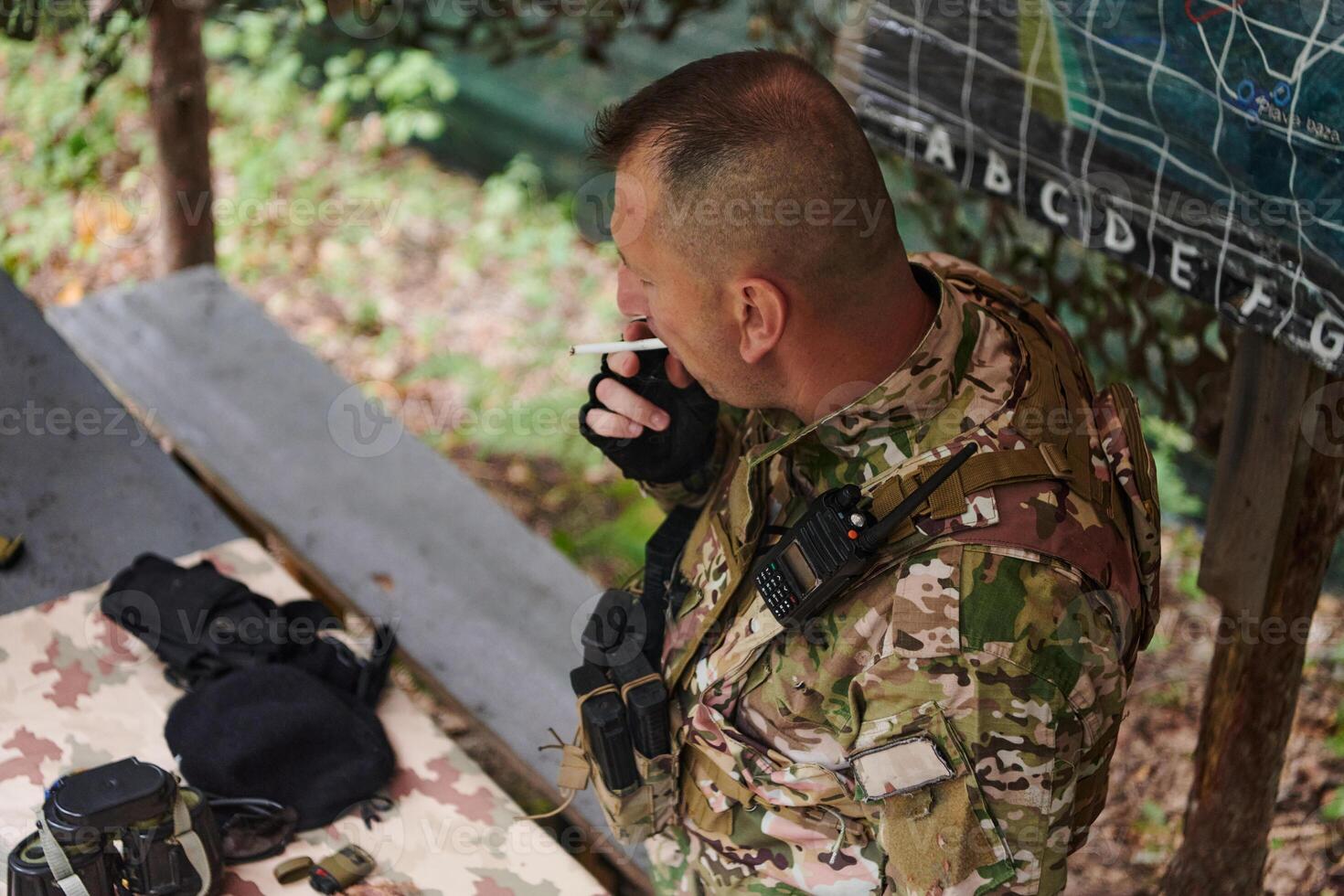 The esteemed leader of an elite military unit, strategic brilliance unfolds as he meticulously devises tactical plans for the upcoming military operation, surrounded by cutting-edge technology and a photo