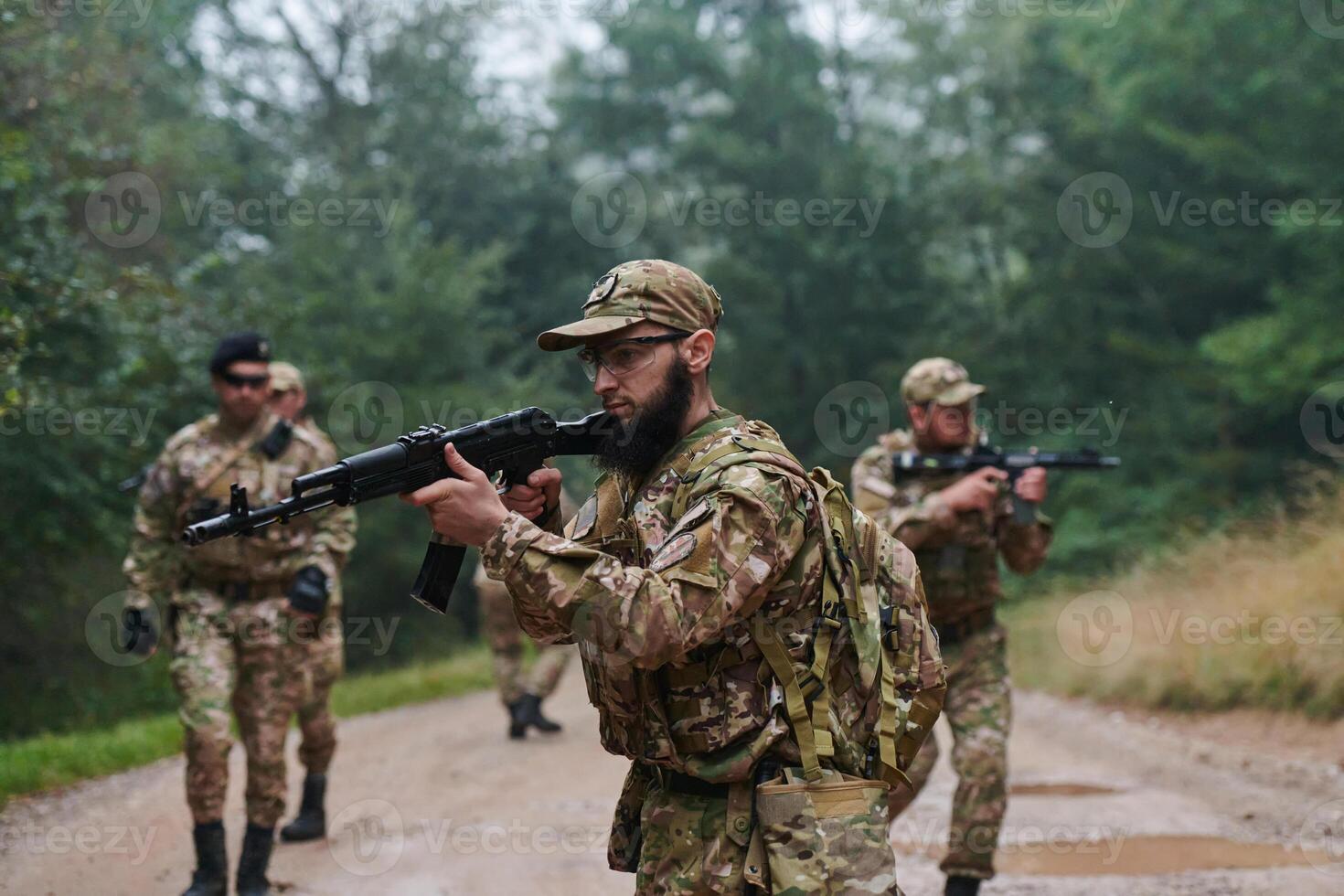 A disciplined and specialized military unit, donned in camouflage, strategically patrolling and maintaining control in a high-stakes environment, showcasing their precision, unity, and readiness for photo
