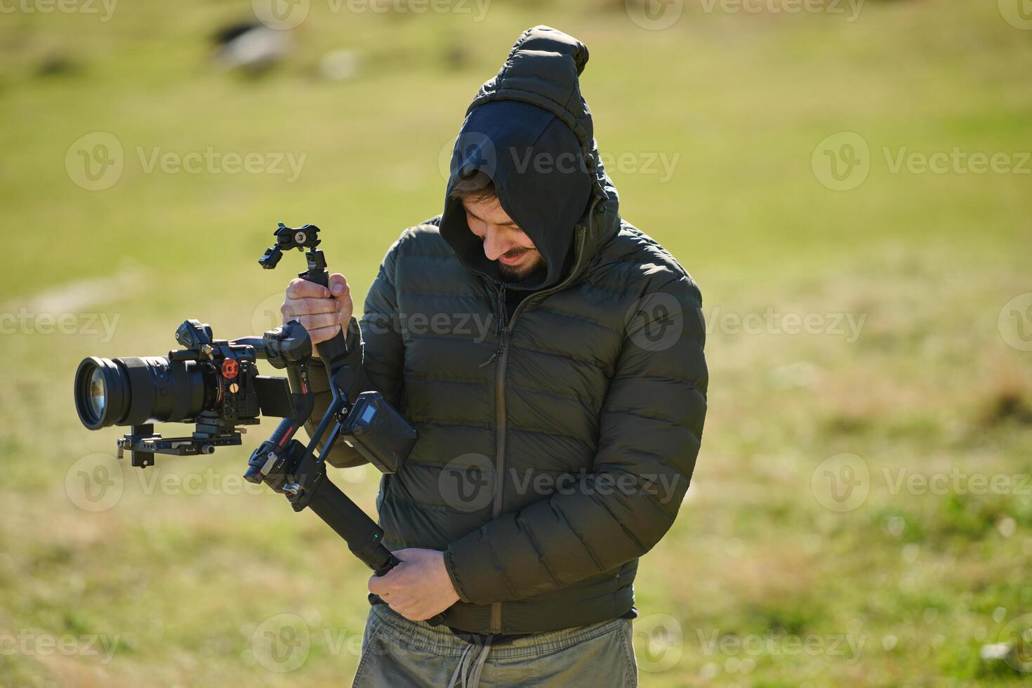 A skilled videographer, equipped with professional gear, captures the essence of nature's beauty, expertly documenting the scenic landscape in a cinematic masterpiece that reflects the seamless blend photo