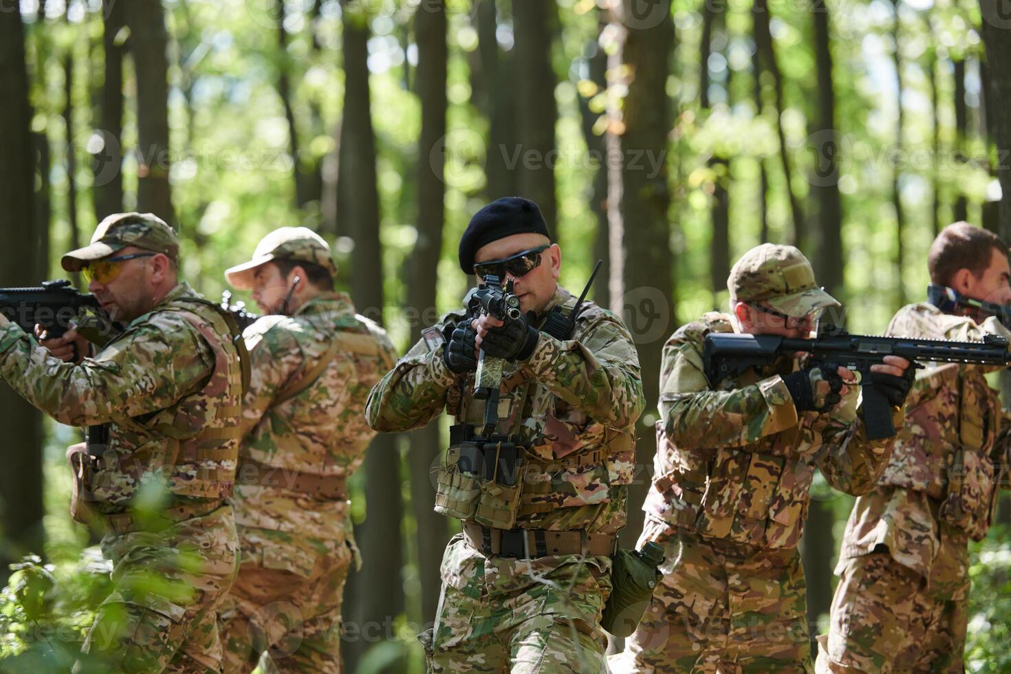 A specialized military antiterrorist unit conducts a covert operation in dense, hazardous woodland, demonstrating precision, discipline, and strategic readiness photo