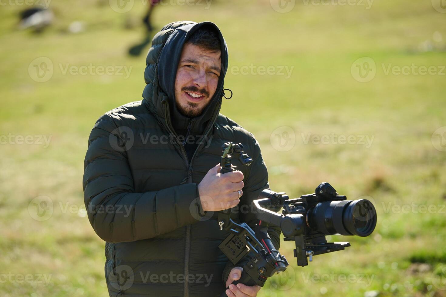 A skilled videographer, equipped with professional gear, captures the essence of nature's beauty, expertly documenting the scenic landscape in a cinematic masterpiece that reflects the seamless blend photo