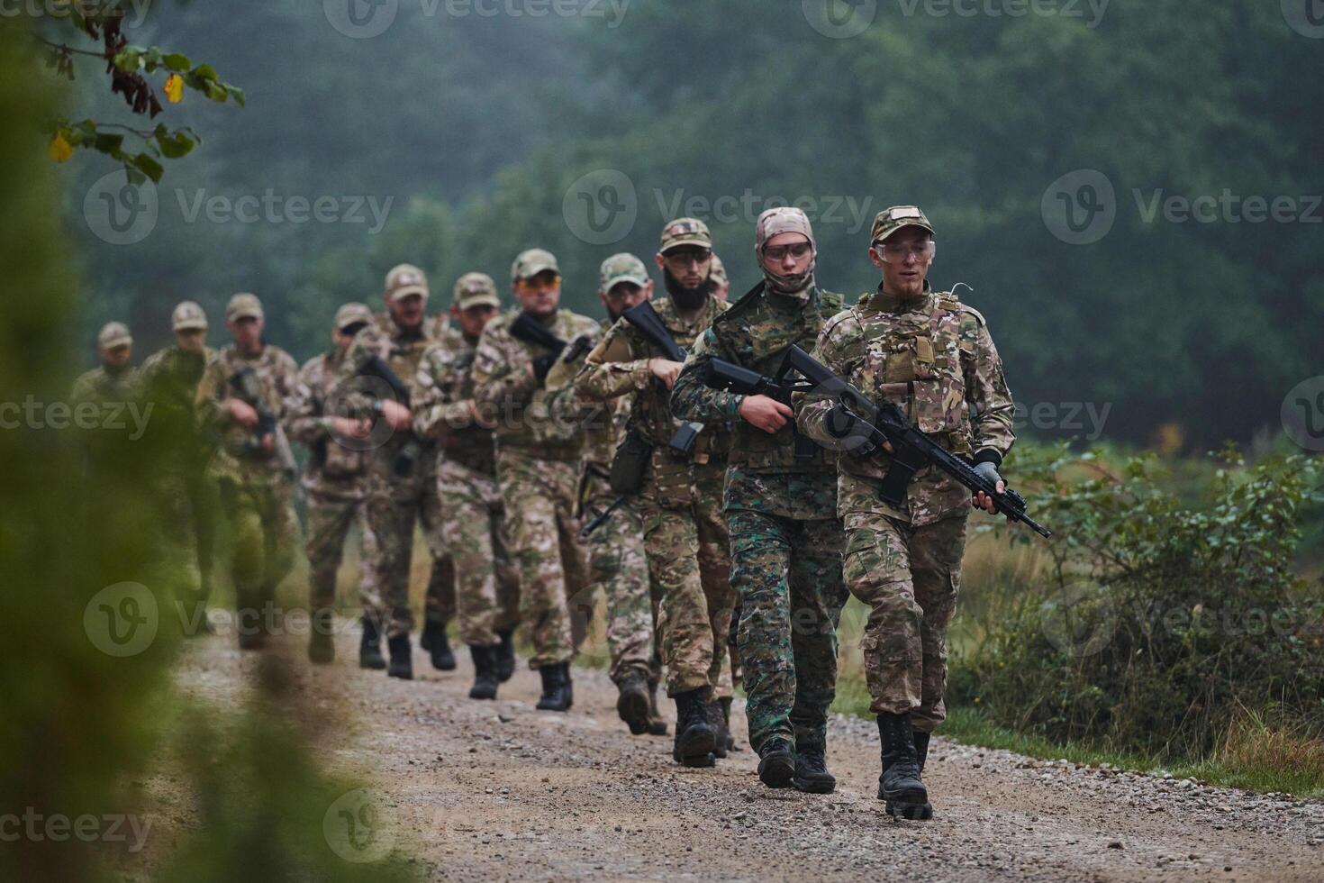 An elite military unit, led by a major, confidently parades through dense forest, showcasing precision, discipline, and readiness for high-risk operations photo