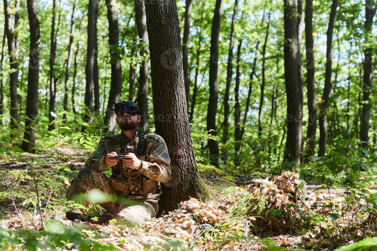 An elite soldier, equipped with state-of-the-art VR glasses, adeptly maneuvers a military drone, showcasing the seamless integration of cutting-edge technology in modern warfare photo
