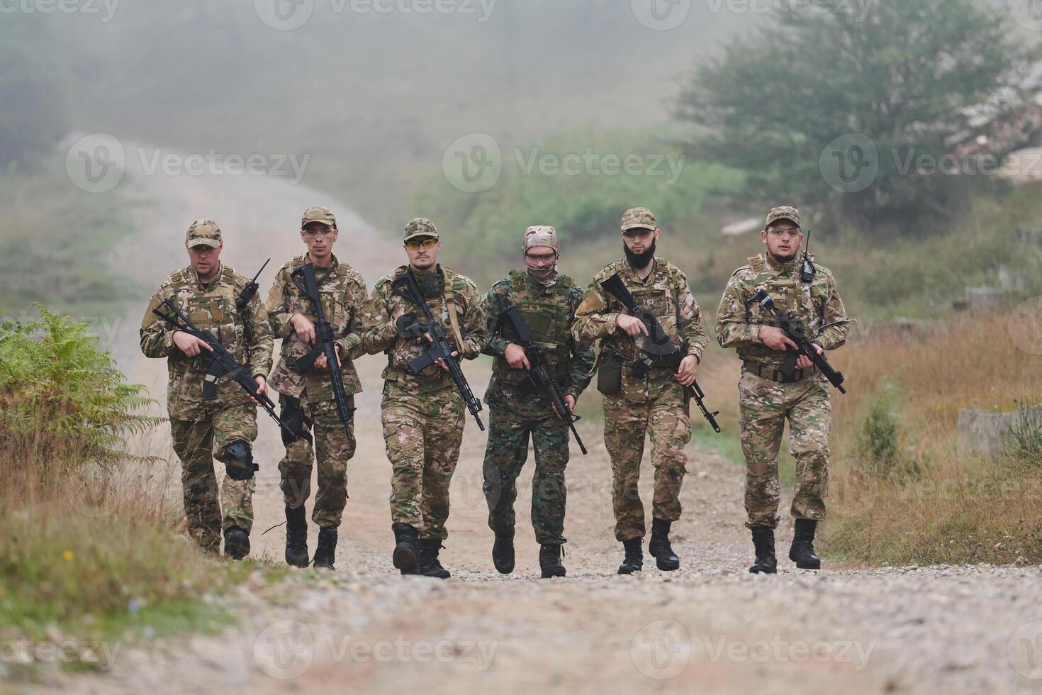 A disciplined and specialized military unit, donned in camouflage, strategically patrolling and maintaining control in a high-stakes environment, showcasing their precision, unity, and readiness for photo