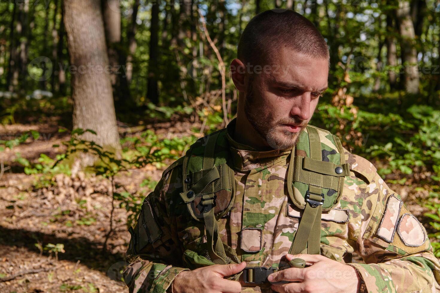 Elite soldier exudes focused determination and readiness, geared up for a perilous military operation, capturing the essence of courage and professionalism in the face of imminent danger photo