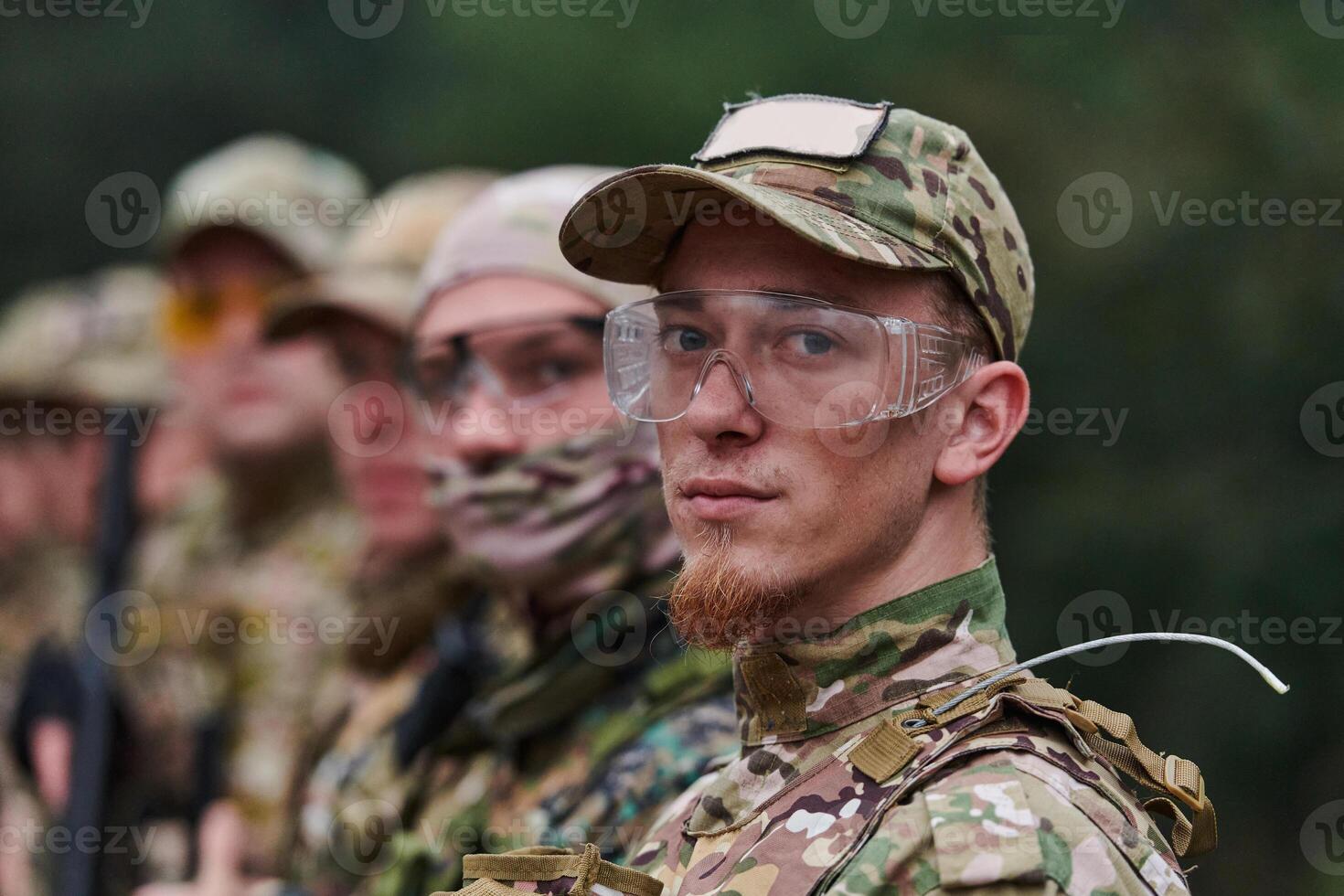 Soldier fighters standing together with guns. Group portrait of US army elite members, private military company servicemen, anti terrorist squad photo