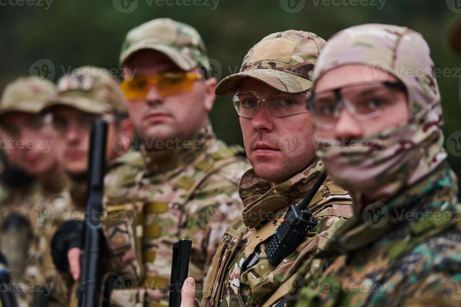 Soldier fighters standing together with guns. Group portrait of US army elite members, private military company servicemen, anti terrorist squad photo