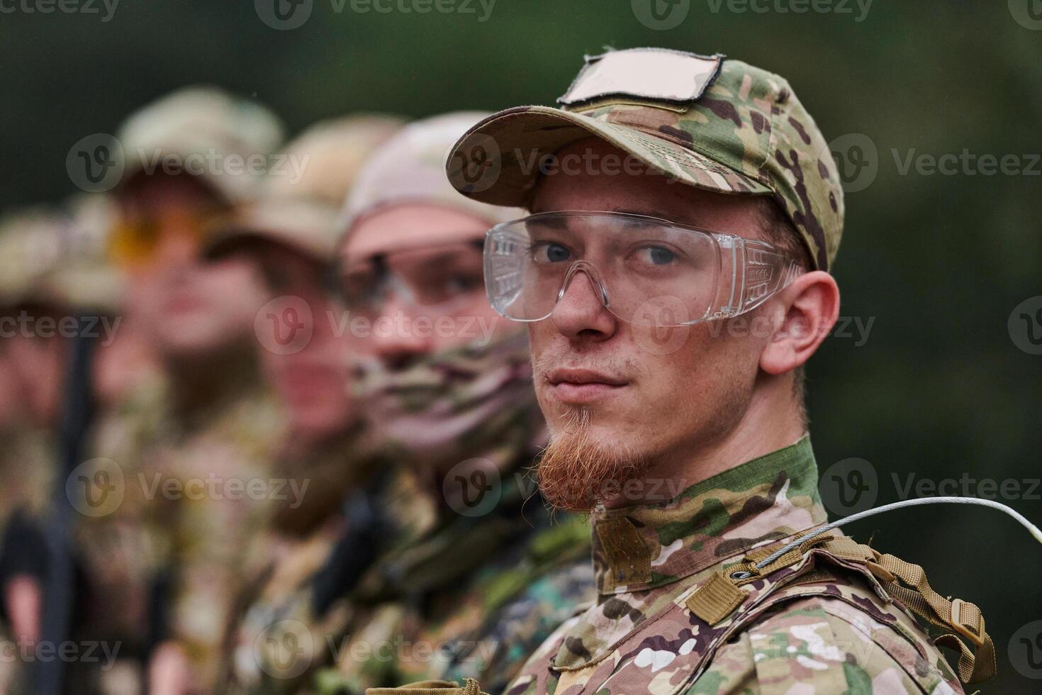 Soldier fighters standing together with guns. Group portrait of US army elite members, private military company servicemen, anti terrorist squad photo