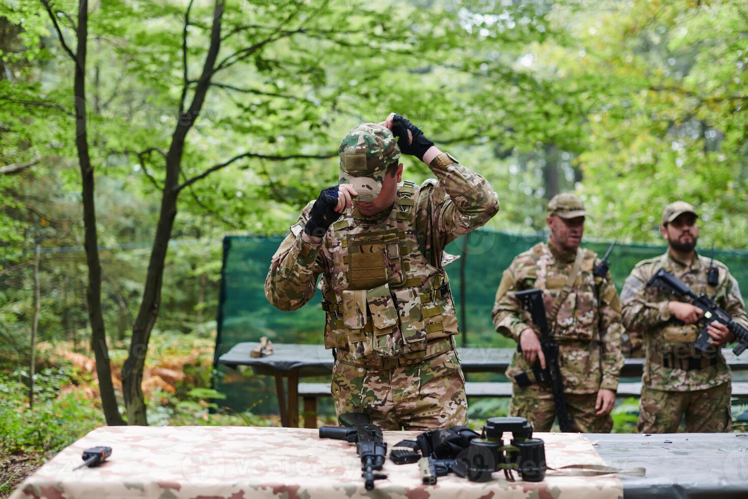 An elite military unit prepares for a hazardous forest operation, showcasing tactical prowess, camouflage skills, and strategic readiness photo