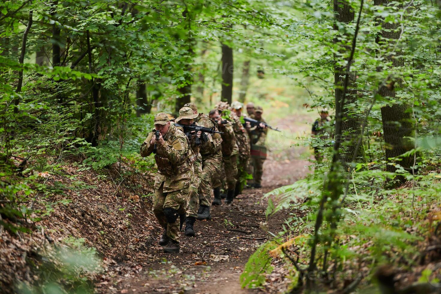 A disciplined and specialized military unit, donned in camouflage, strategically patrolling and maintaining control in a high-stakes environment, showcasing their precision, unity, and readiness for photo