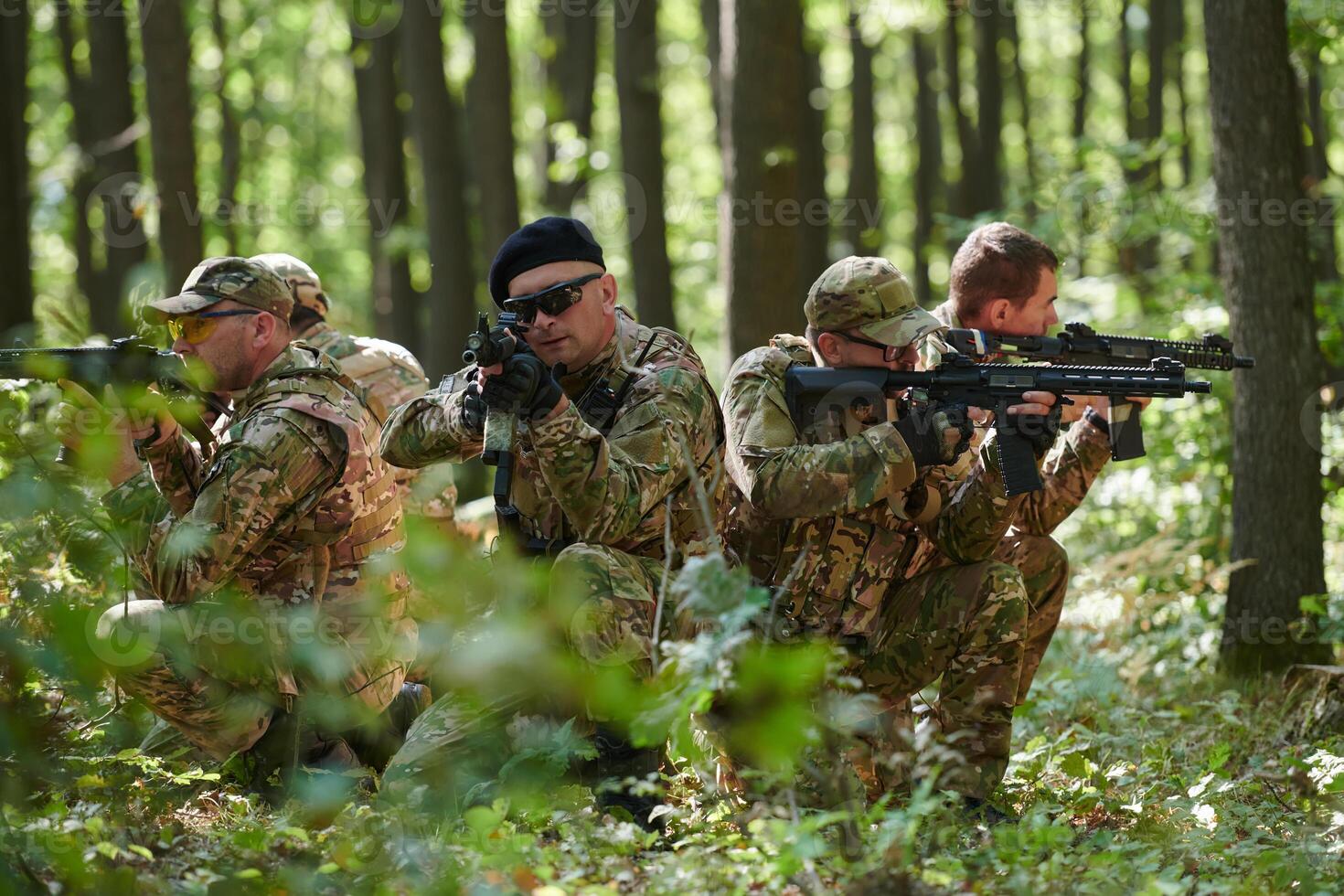 A specialized military antiterrorist unit conducts a covert operation in dense, hazardous woodland, demonstrating precision, discipline, and strategic readiness photo