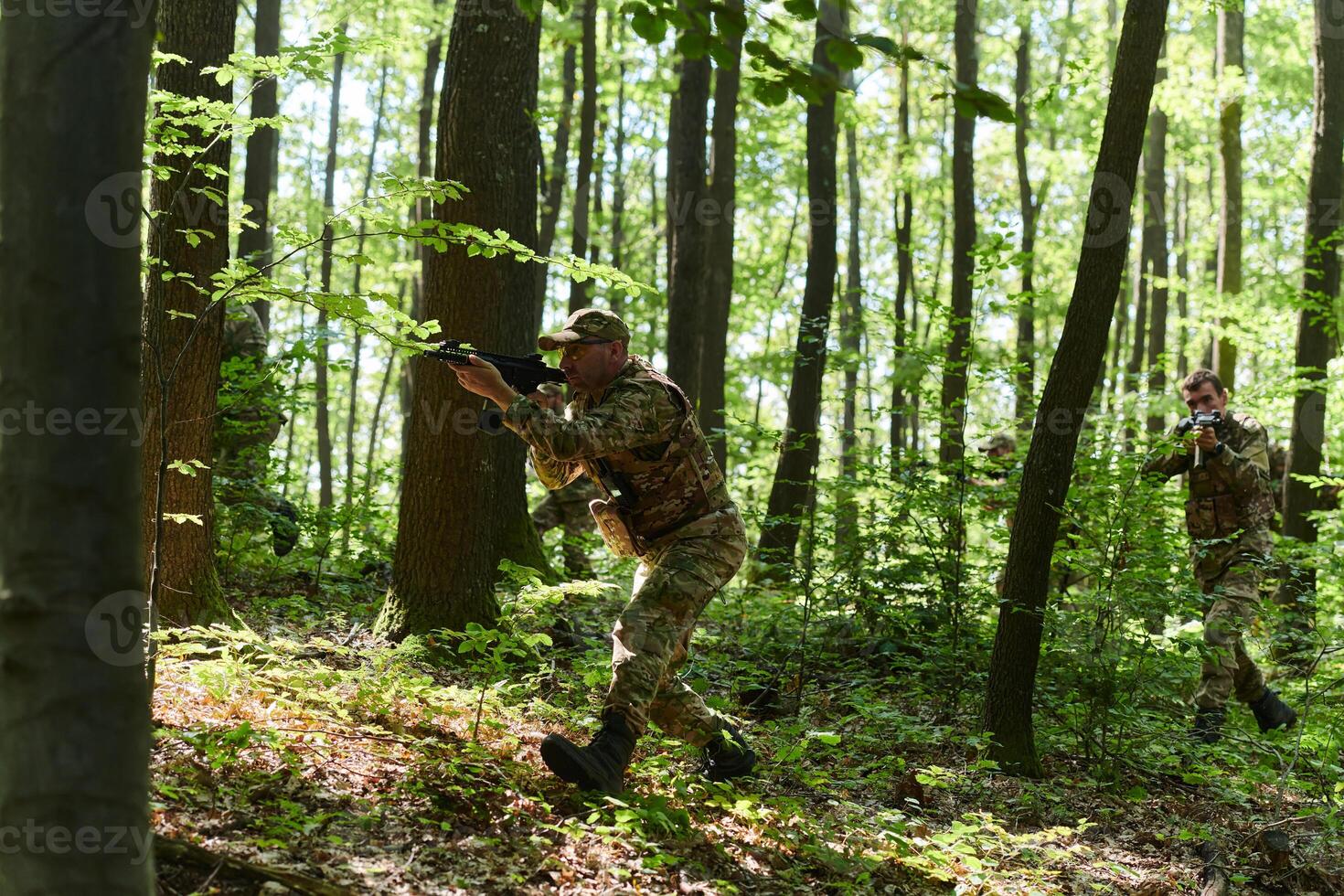 A specialized military antiterrorist unit conducts a covert operation in dense, hazardous woodland, demonstrating precision, discipline, and strategic readiness photo