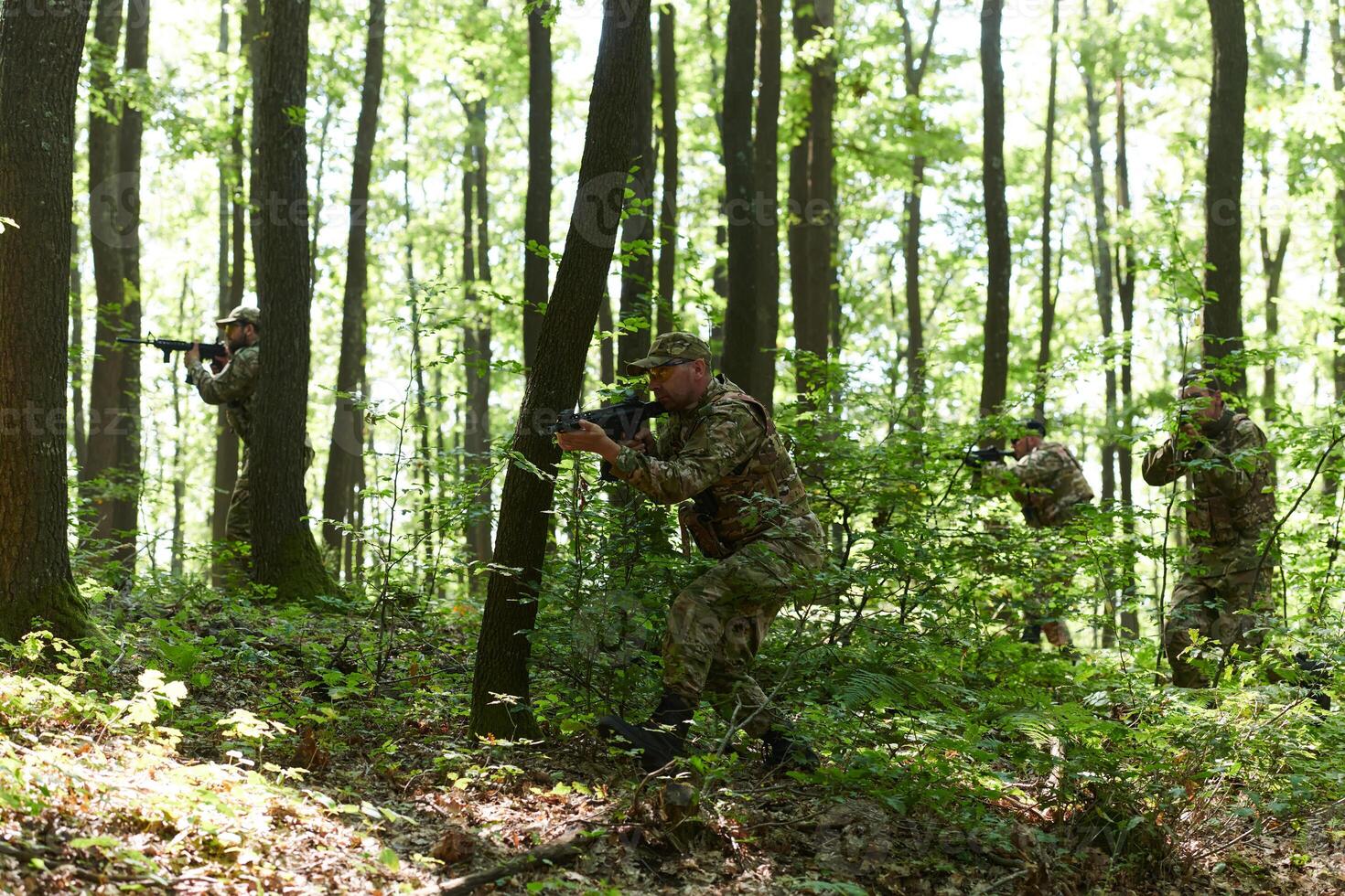 A specialized military antiterrorist unit conducts a covert operation in dense, hazardous woodland, demonstrating precision, discipline, and strategic readiness photo