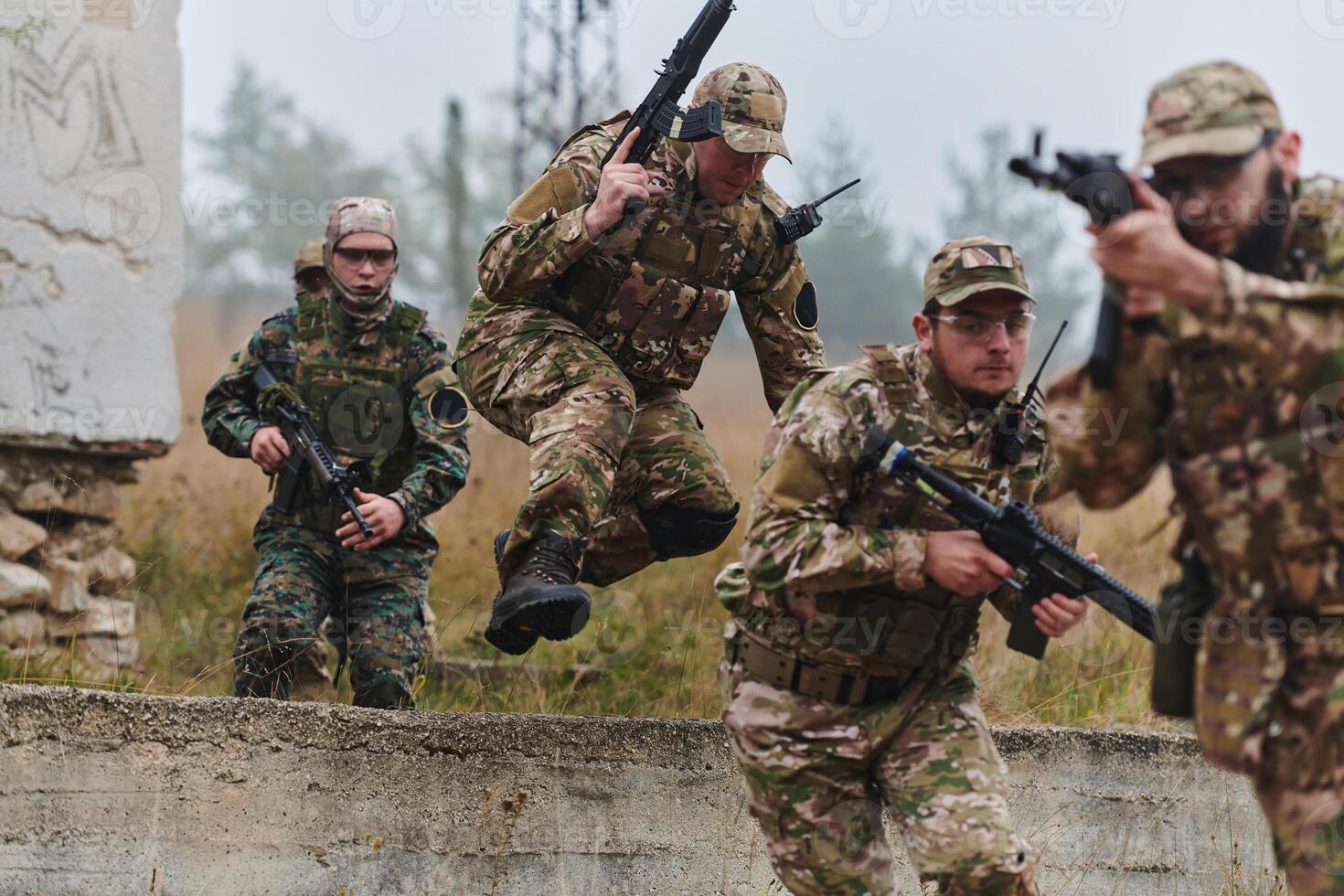 A highly trained elite military unit, clad in camouflage, skillfully navigates through perilous forest terrain, overcoming obstacles and executing a precise and covert mission photo