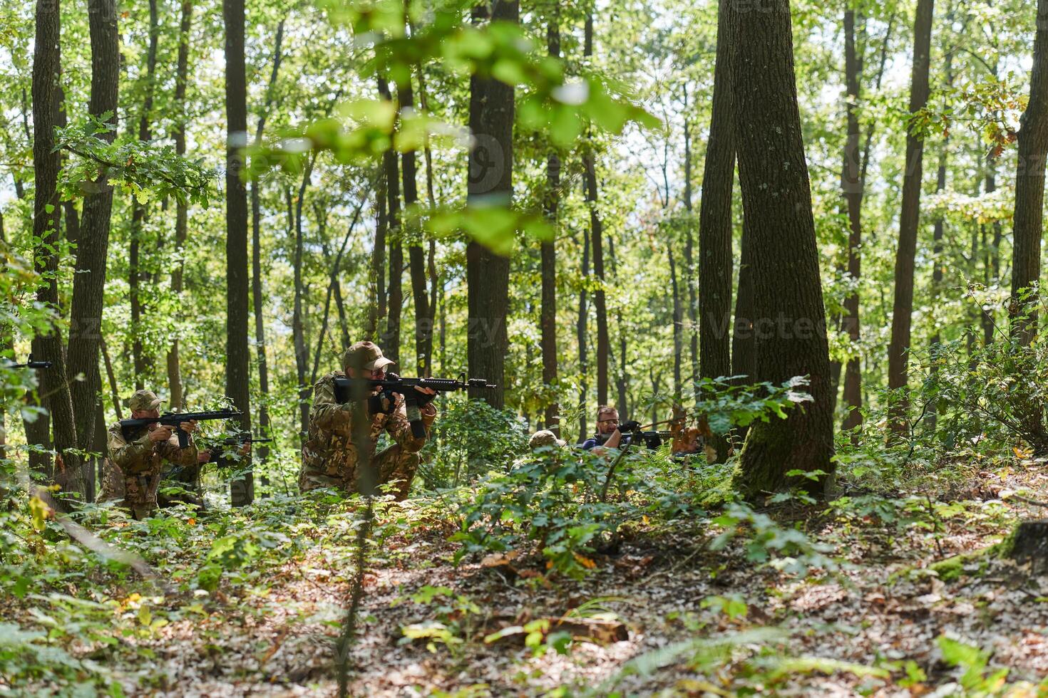 A specialized military antiterrorist unit conducts a covert operation in dense, hazardous woodland, demonstrating precision, discipline, and strategic readiness photo