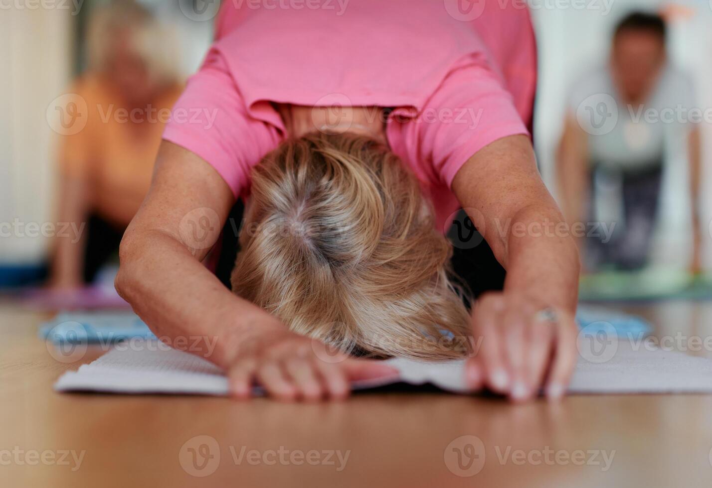 Senior Woman Practicing Back Stretches in a Sunlit Space for Optimal Health and Well Being photo