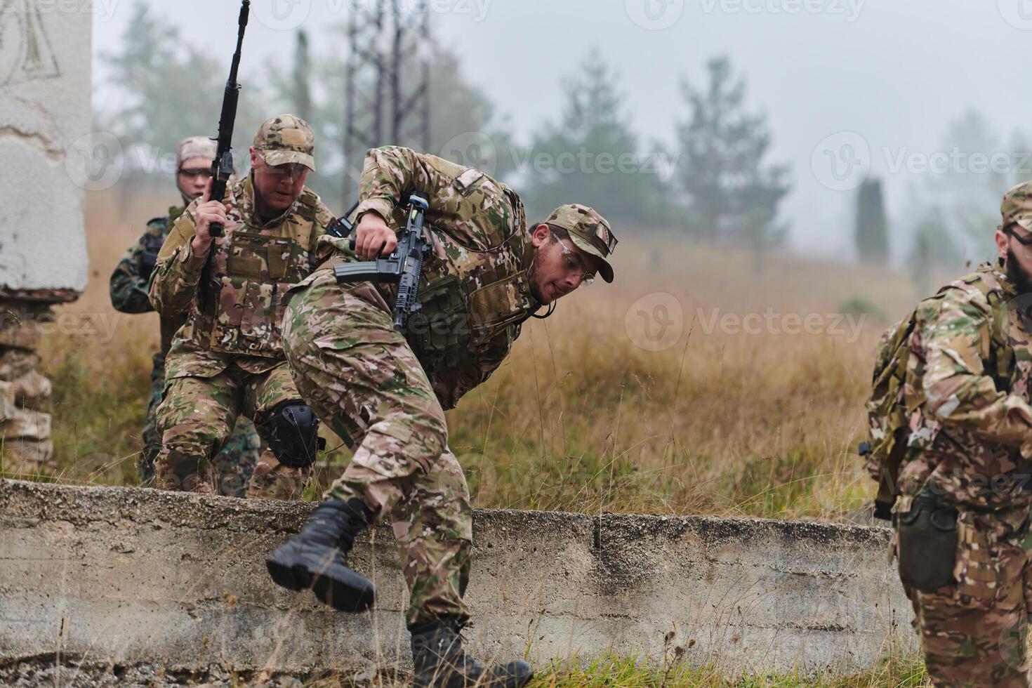 A highly trained elite military unit, clad in camouflage, skillfully navigates through perilous forest terrain, overcoming obstacles and executing a precise and covert mission photo