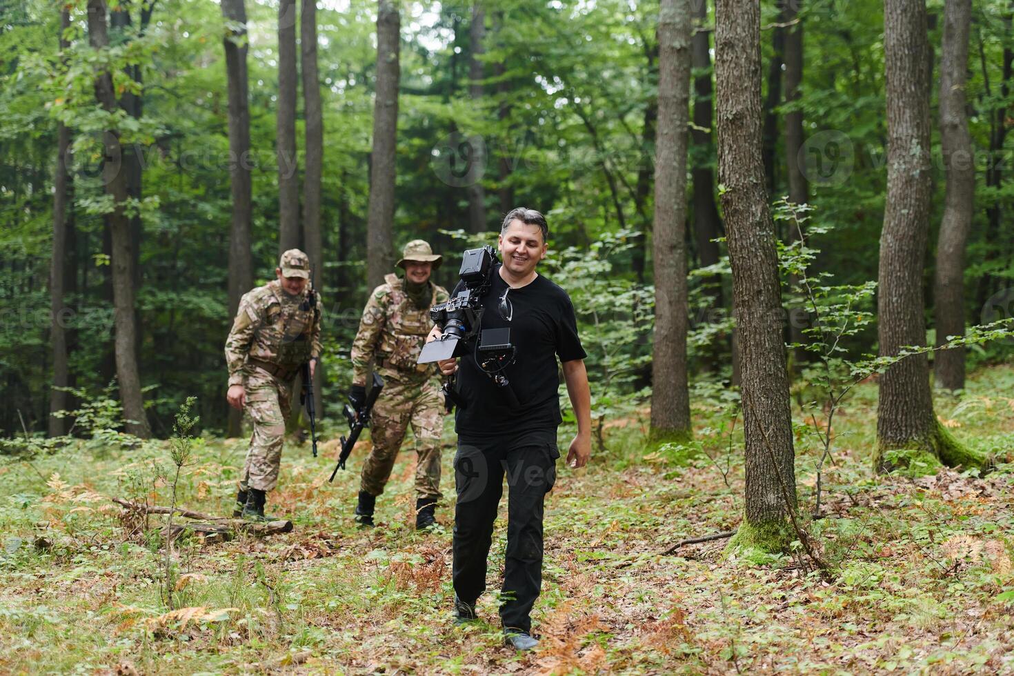 A videographer captures the intensity of a perilous military operation, documenting soldiers in action amidst the dense forest, showcasing the hazardous conditions and tactical maneuvers undertaken by photo