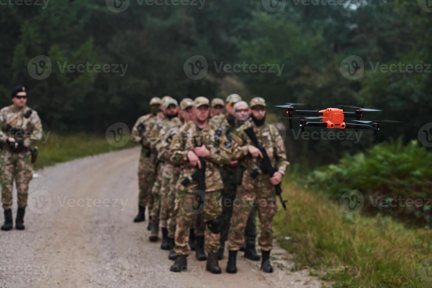 An elite military unit, led by a major, confidently parades through dense forest, showcasing precision, discipline, and readiness for high-risk operations photo