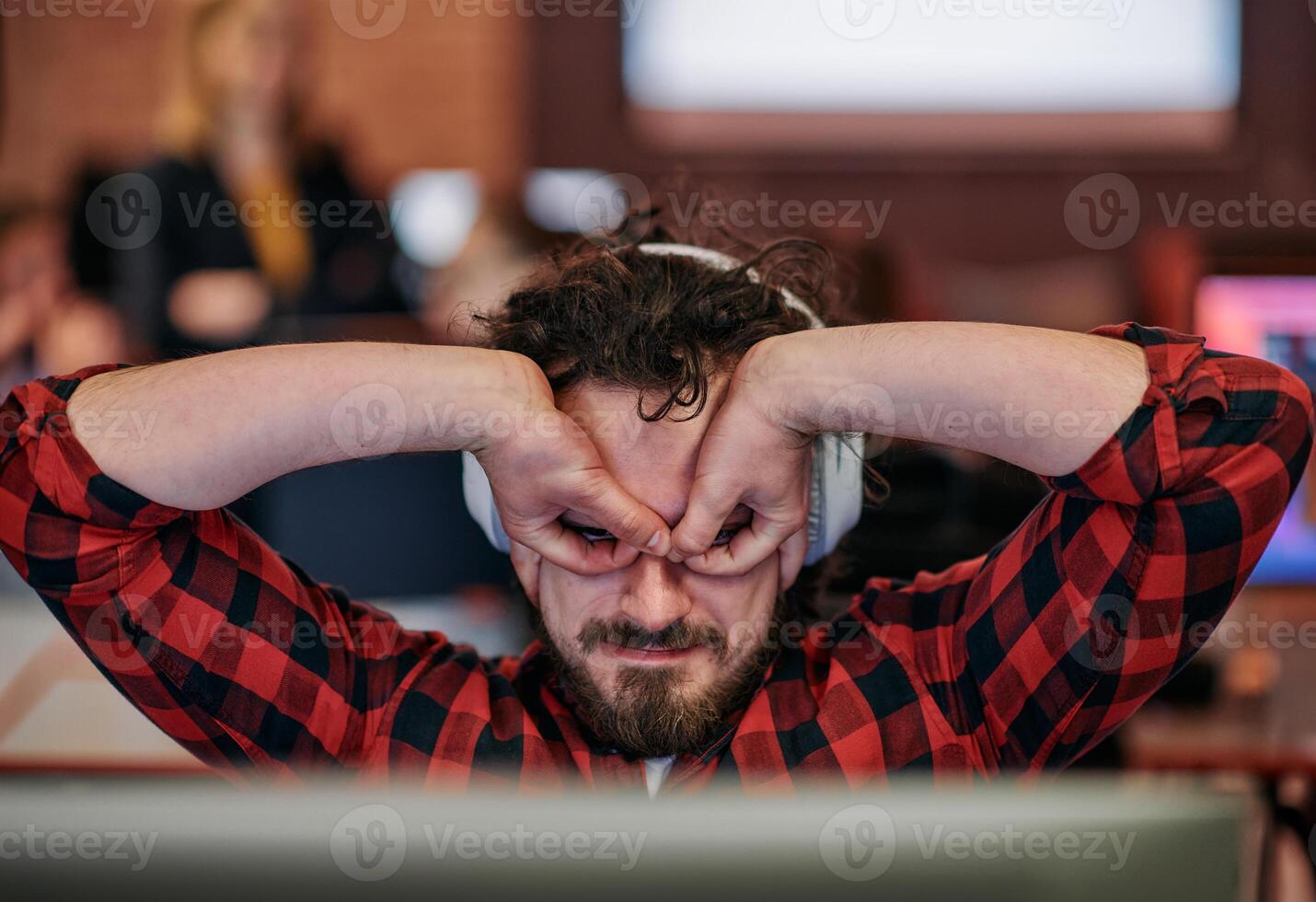 Joyful Collaboration. A Man Embracing Remote Work with Enthusiastic Gestures in a Coworking Space. photo
