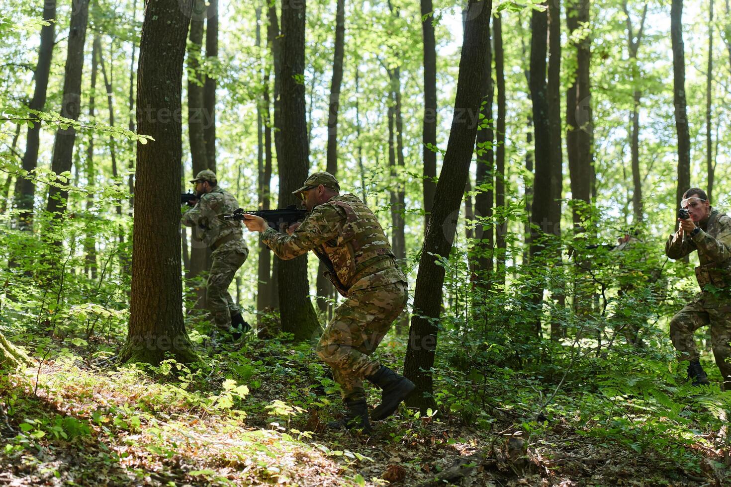A specialized military antiterrorist unit conducts a covert operation in dense, hazardous woodland, demonstrating precision, discipline, and strategic readiness photo
