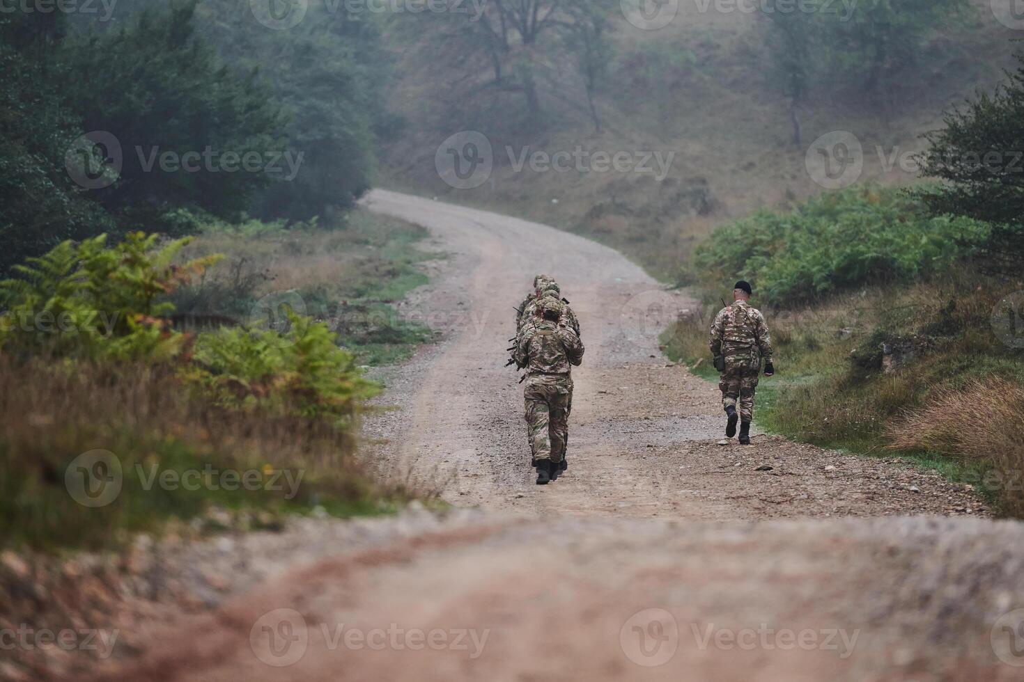 A disciplined and specialized military unit, donned in camouflage, strategically patrolling and maintaining control in a high-stakes environment, showcasing their precision, unity, and readiness for photo