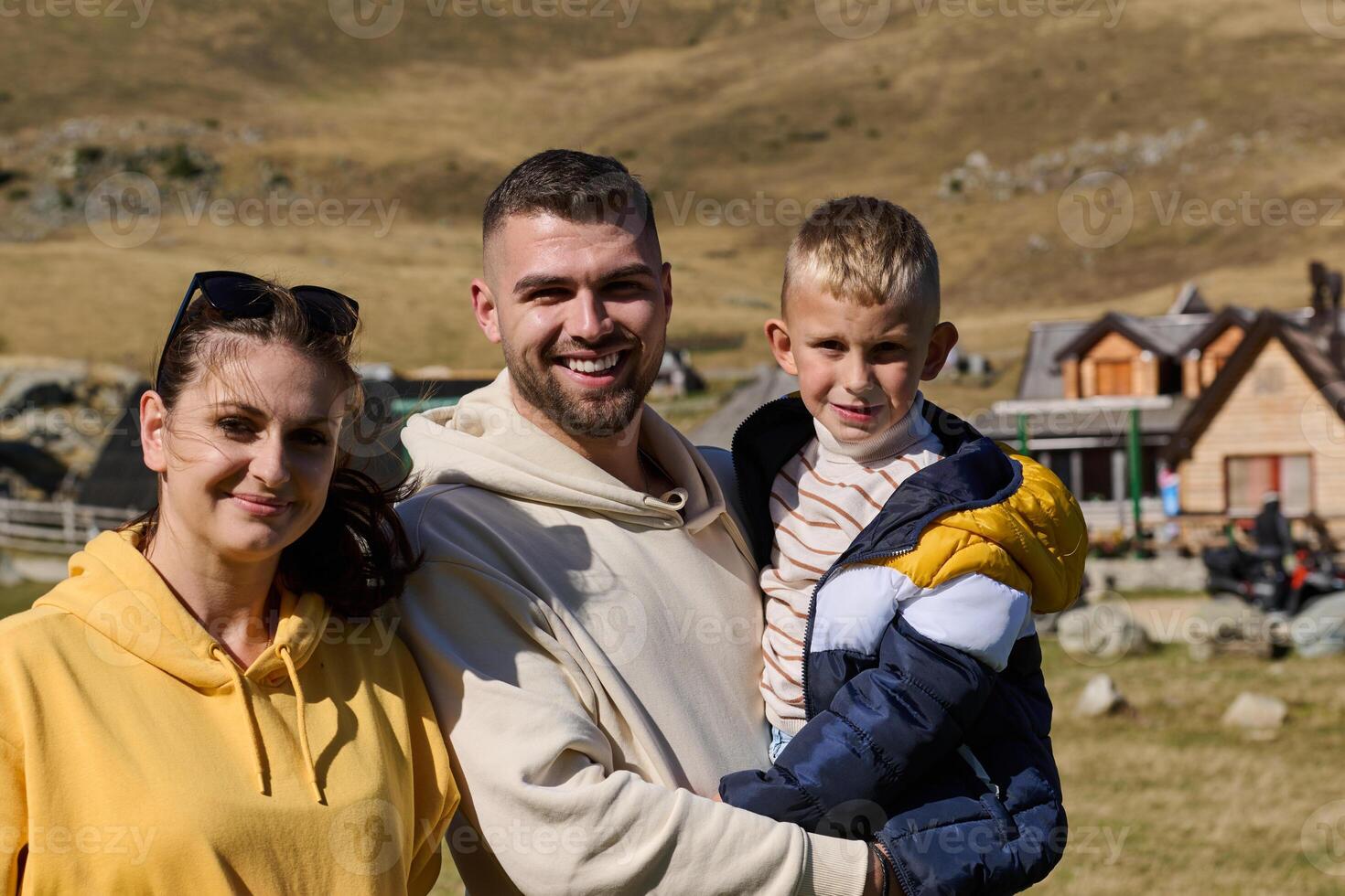 A modern family, along with their son, revels in the joy of a muddy day in nature, running and playing together, encapsulating the beauty of a healthy and active lifestyle photo