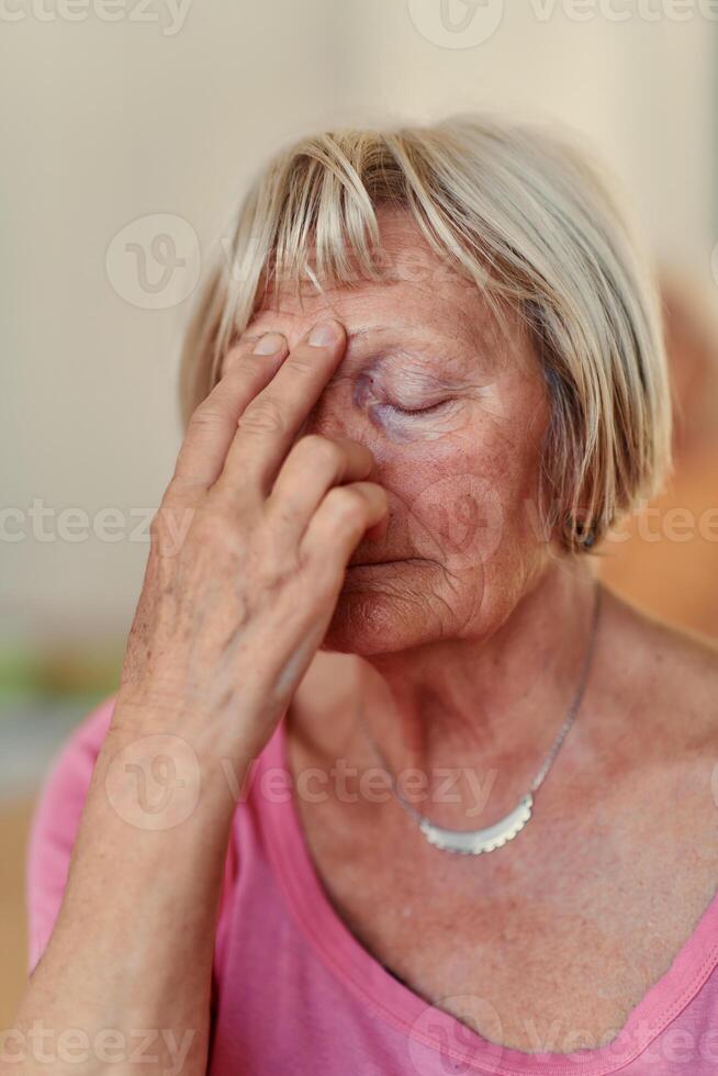 Senior Woman Practicing Calming Traditional Exercises with a Gentle Forehead Gesture photo