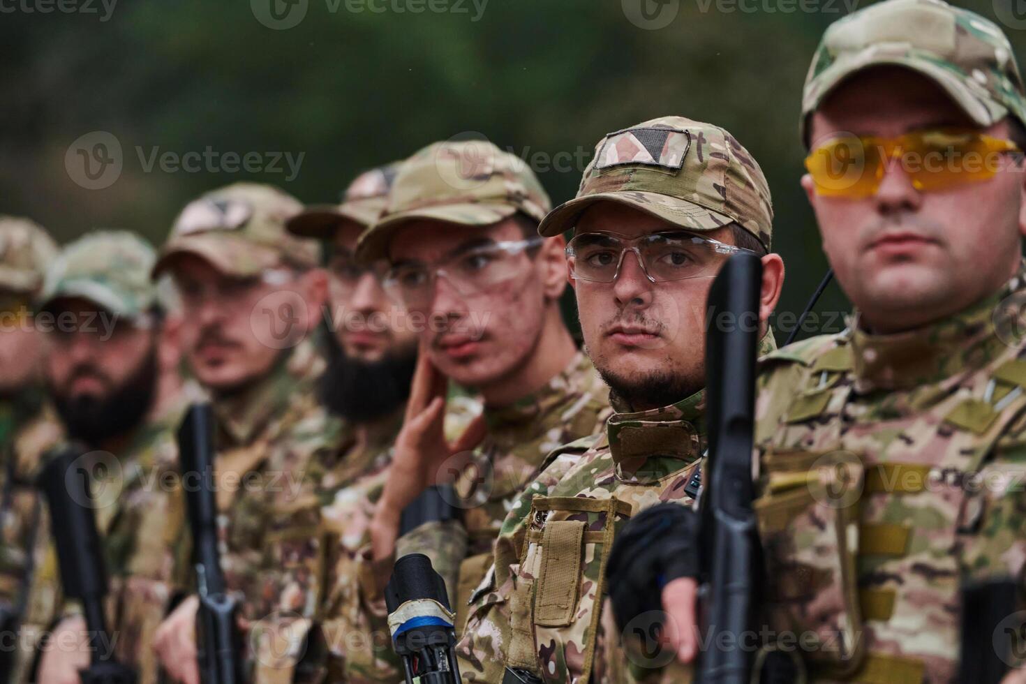 Soldier fighters standing together with guns. Group portrait of US army elite members, private military company servicemen, anti terrorist squad photo