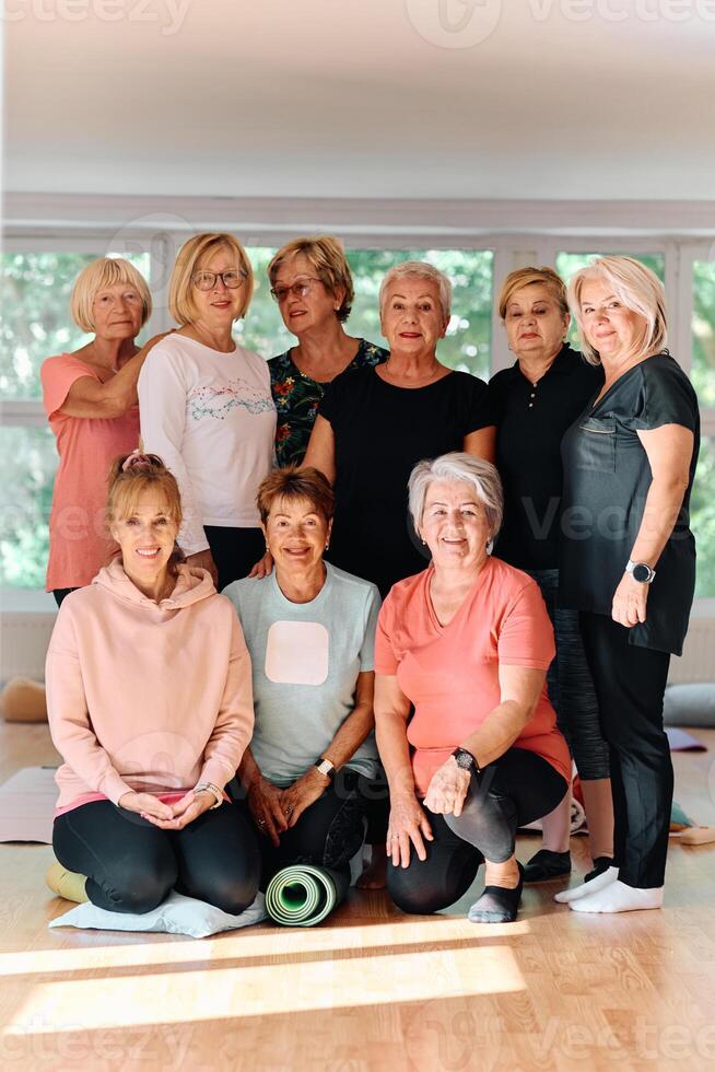 A vibrant community of senior women, guided by their instructor, embraces the enriching journey of yoga, fostering unity, well-being, and a shared commitment to active aging photo